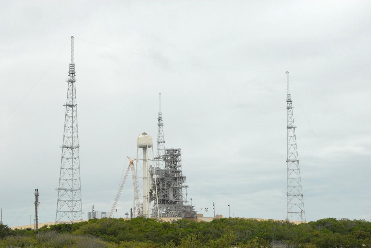 CAPE CANAVERAL, Fla. – On Launch Pad 39B at NASA's Kennedy Space Center in Florida, catenary wires are being suspended from the lighting masts on the lightning towers.  The catenary wire system under development for the Constellation Program’s next-generation vehicles will significantly increase the shielding level, providing better protection, and further separate the electrical current from vital launch hardware. The system will help avoid delays to the launch schedule by collecting more information on the strike for analysis by launch managers.  Photo credit: NASA/Jack Pfaller