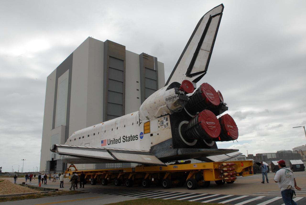 CAPE CANAVERAL, Fla. – On its transporter, space shuttle Atlantis rolls toward the Vehicle Assembly Building (in the background) after leaving Orbiter Processing Facility 1 at NASA's Kennedy Space Center in Florida. First motion was at 11:30 a.m. EDT. In the VAB, Atlantis will be lifted into High Bay 3 and mated to the solid rocket booster-external fuel tank already installed on the mobile launcher platform. Atlantis is targeted to launch May 12 for the STS-125 Hubble servicing mission. Photo credit: NASA/Jack Pfaller