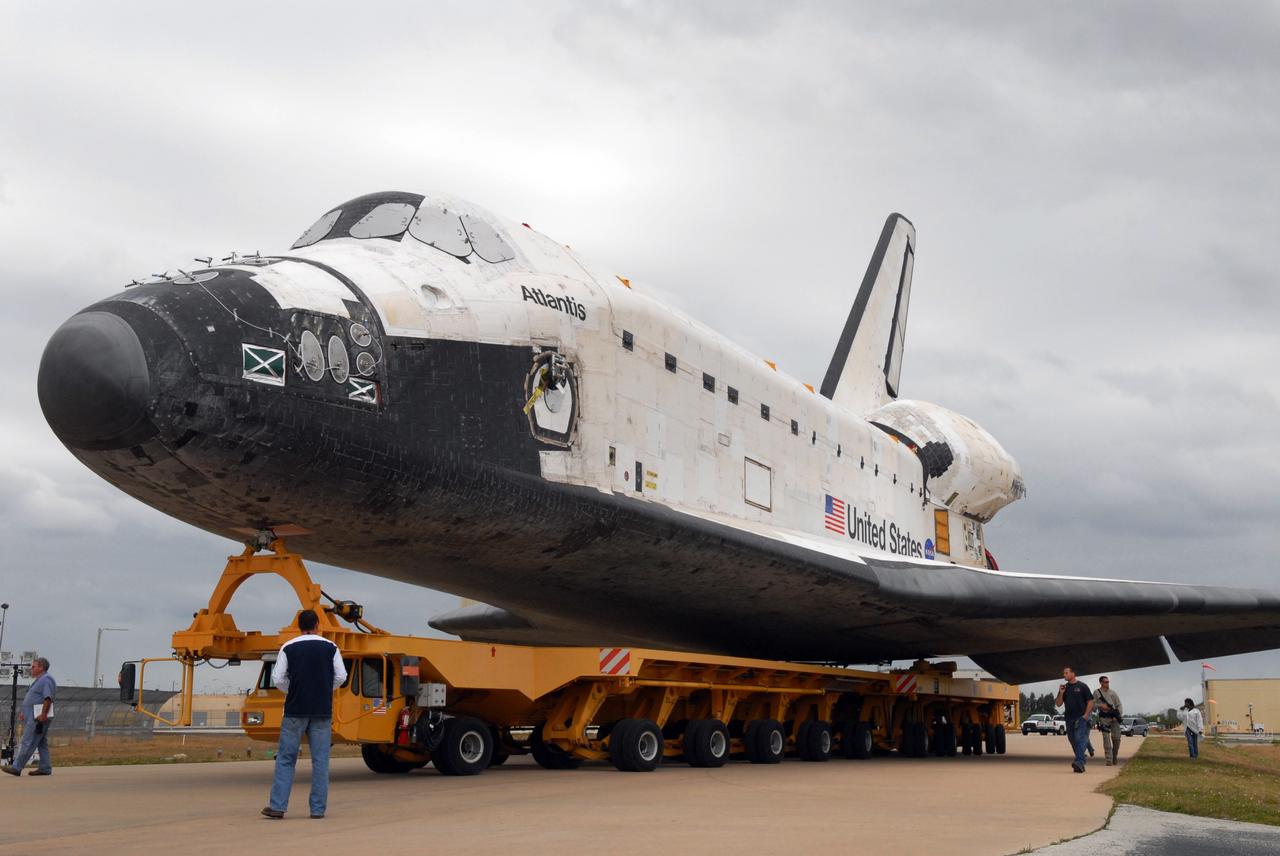 CAPE CANAVERAL, Fla. – On its transporter, space shuttle Atlantis rolls toward the Vehicle Assembly Building after leaving Orbiter Processing Facility 1 at NASA's Kennedy Space Center in Florida. First motion was at 11:30 a.m. EDT. In the VAB, Atlantis will be lifted into High Bay 3 and mated to the solid rocket booster-external fuel tank already installed on the mobile launcher platform.Atlantis is targeted to launch May 12 for the STS-125 Hubble servicing mission. Photo credit: NASA/Jack Pfaller