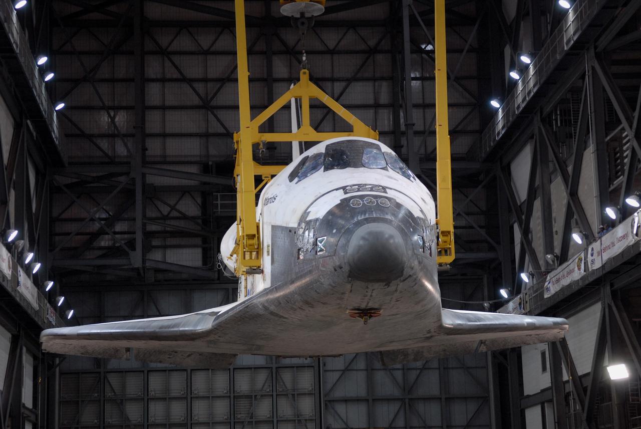 CAPE CANAVERAL, Fla. – In the Vehicle Assembly Building at NASA's Kennedy Space Center in Florida, space shuttle Atlantis is suspended by a crane while its transporter is moved away from the transfer aisle. The shuttle will be raised to a vertical position and lifted into High Bay 3 where it will be attached to its external fuel tank and solid rocket boosters on the mobile launcher platform. After additional preparations are made, the shuttle will be rolled out to Launch Pad 39A for a targeted launch on May 12 on the STS-125 Hubble servicing mission. Photo credit: NASA/Cory Huston