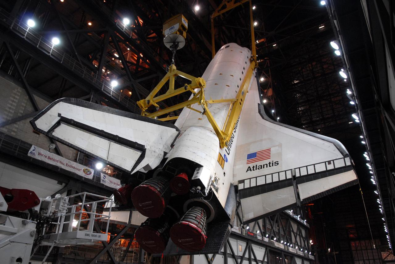 CAPE CANAVERAL, Fla. – In the Vehicle Assembly Building at NASA's Kennedy Space Center in Florida, the crane holding space shuttle Atlantis rotates it toward a vertical position above the transfer aisle. The shuttle will be lifted into High Bay 3 where it will be attached to its external fuel tank and solid rocket boosters on the mobile launcher platform. After additional preparations are made, the shuttle will be rolled out to Launch Pad 39A for a targeted launch on May 12 on the STS-125 Hubble servicing mission. Photo credit: NASA/Cory Huston