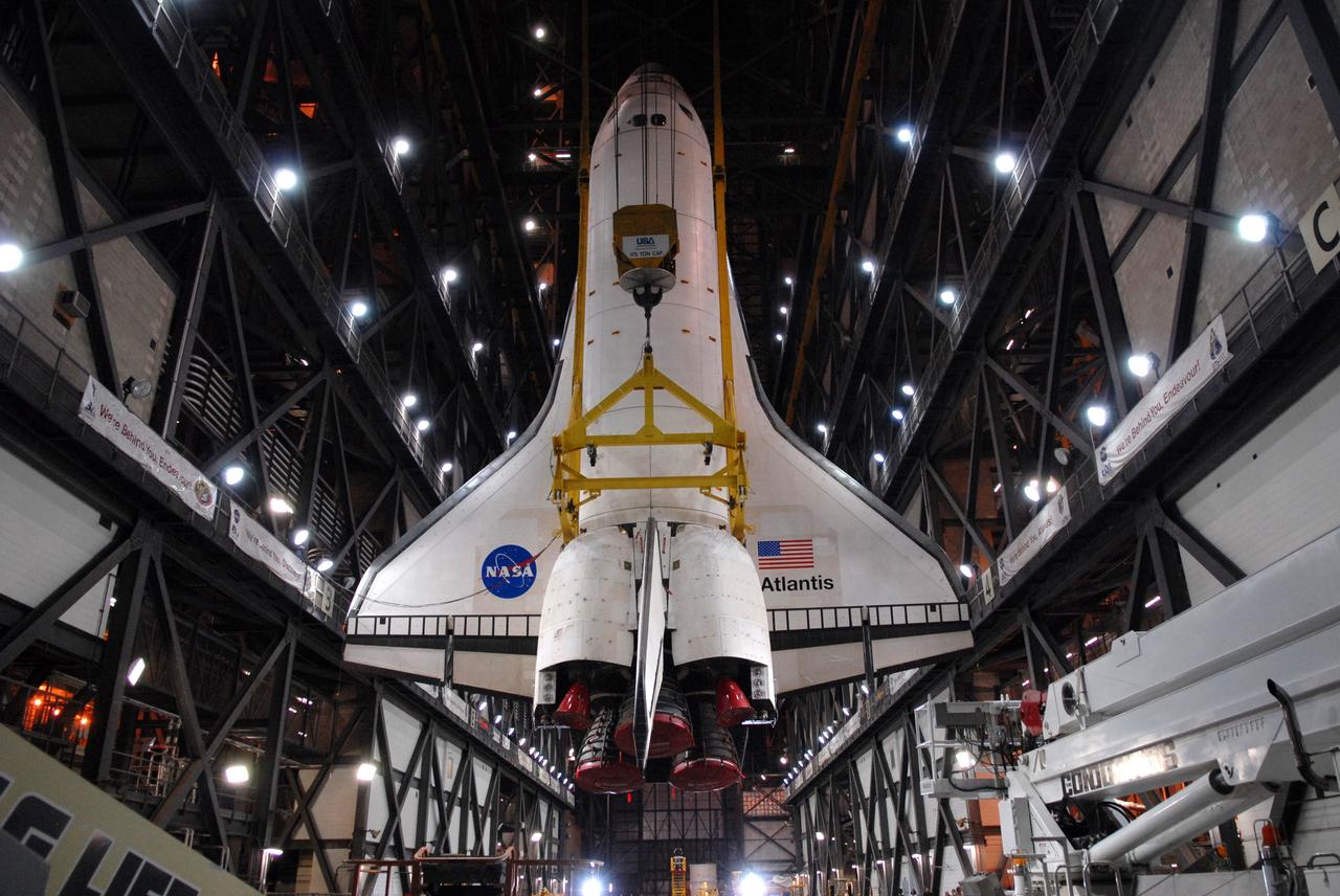 CAPE CANAVERAL, Fla. – After rotation in the Vehicle Assembly Building at NASA's Kennedy Space Center in Florida, space shuttle Atlantis is suspended vertically above the transfer aisle. The shuttle will be lifted into High Bay 3 where it will be attached to its external fuel tank and solid rocket boosters on the mobile launcher platform. After additional preparations are made, the shuttle will be rolled out to Launch Pad 39A for a targeted launch on May 12 on the STS-125 Hubble servicing mission. Photo credit: NASA/Cory Huston