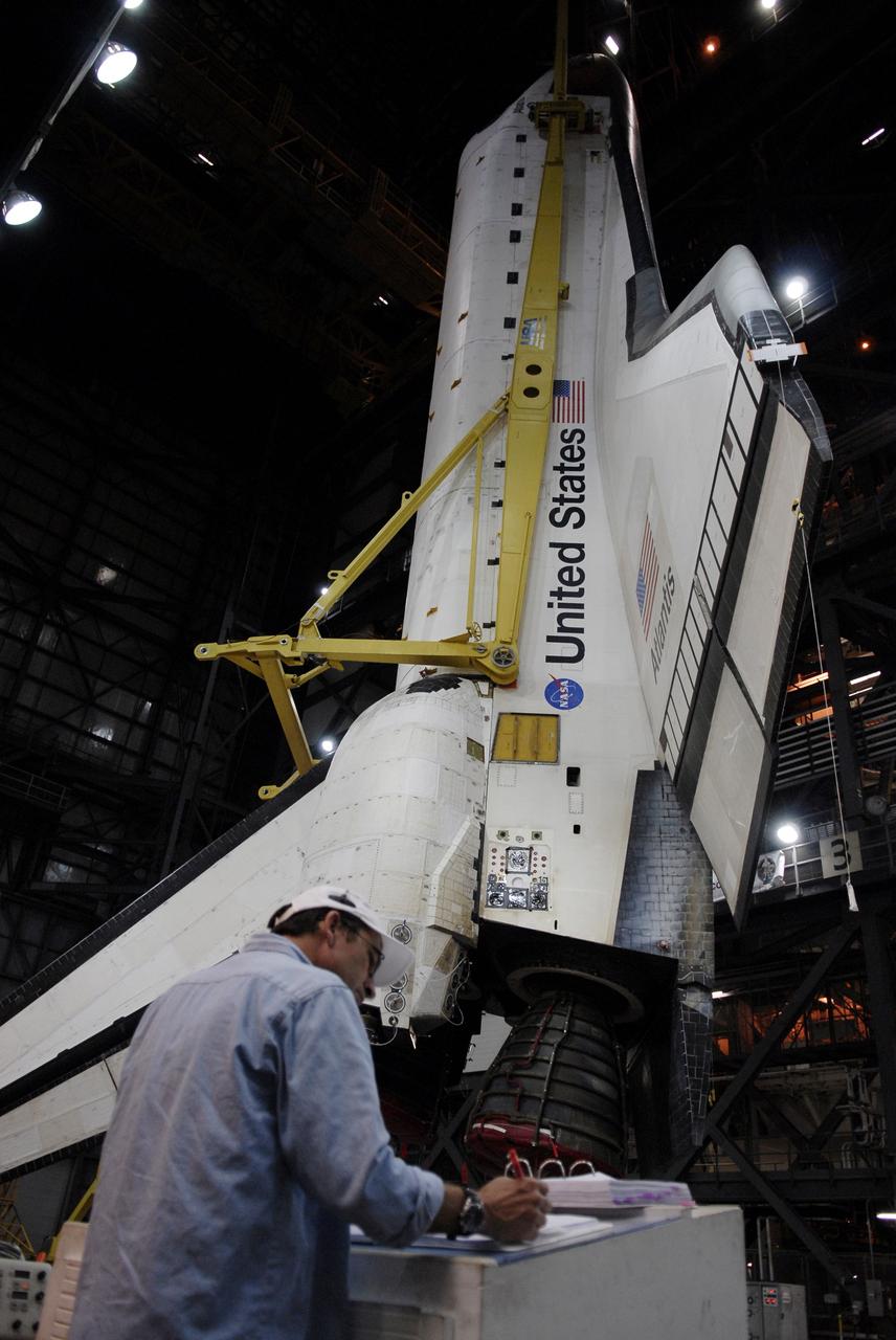 CAPE CANAVERAL, Fla. – In the Vehicle Assembly Building at NASA's Kennedy Space Center in Florida, a technician checks data before space shuttle Atlantis is lifted into High Bay 3. In the bay, the shuttle will be lowered and mated with its external fuel tank and solid rocket boosters on the mobile launcher platform. After additional preparations are made, the shuttle will be rolled out to Launch Pad 39A for a targeted launch on May 12 on the STS-125 mission to service NASA's Hubble Space Telescope. Photo credit: NASA/Kim Shiflett