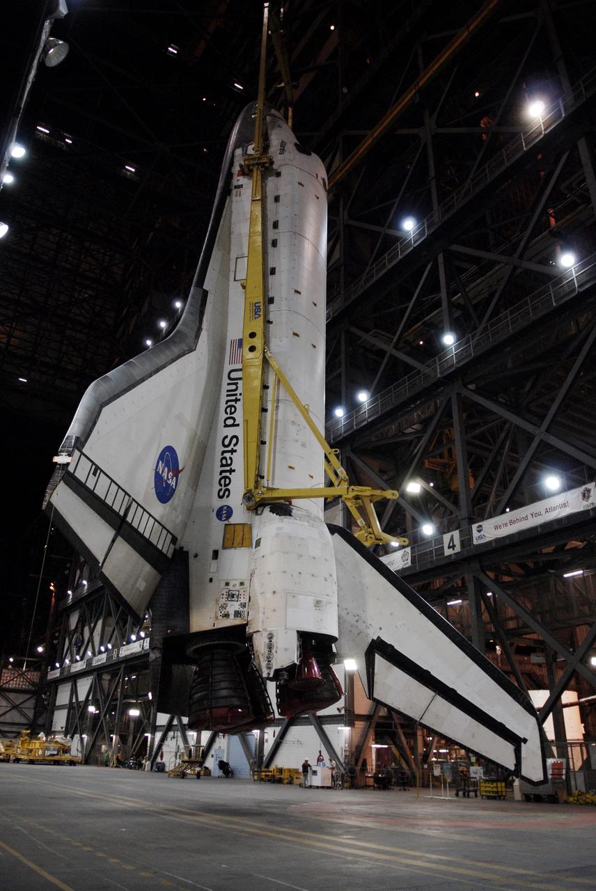 CAPE CANAVERAL, Fla. – In the Vehicle Assembly Building at NASA's Kennedy Space Center in Florida, a crane begins to lift space shuttle Atlantis into the upper levels to move it into High Bay 3. In the bay, the shuttle will be lowered and mated with its external fuel tank and solid rocket boosters on the mobile launcher platform. After additional preparations are made, the shuttle will be rolled out to Launch Pad 39A for a targeted launch on May 12 on the STS-125 mission to service NASA's Hubble Space Telescope. Photo credit: NASA/Kim Shiflett