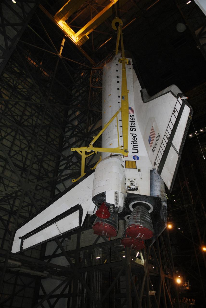 CAPE CANAVERAL, Fla. – In the Vehicle Assembly Building at NASA's Kennedy Space Center in Florida, space shuttle Atlantis is lifted toward the upper levels where it can be moved into High Bay 3. In the bay, the shuttle will be lowered and mated with its external fuel tank and solid rocket boosters on the mobile launcher platform. After additional preparations are made, the shuttle will be rolled out to Launch Pad 39A for a targeted launch on May 12 on the STS-125 mission to service NASA's Hubble Space Telescope. Photo credit: NASA/Kim Shiflett
