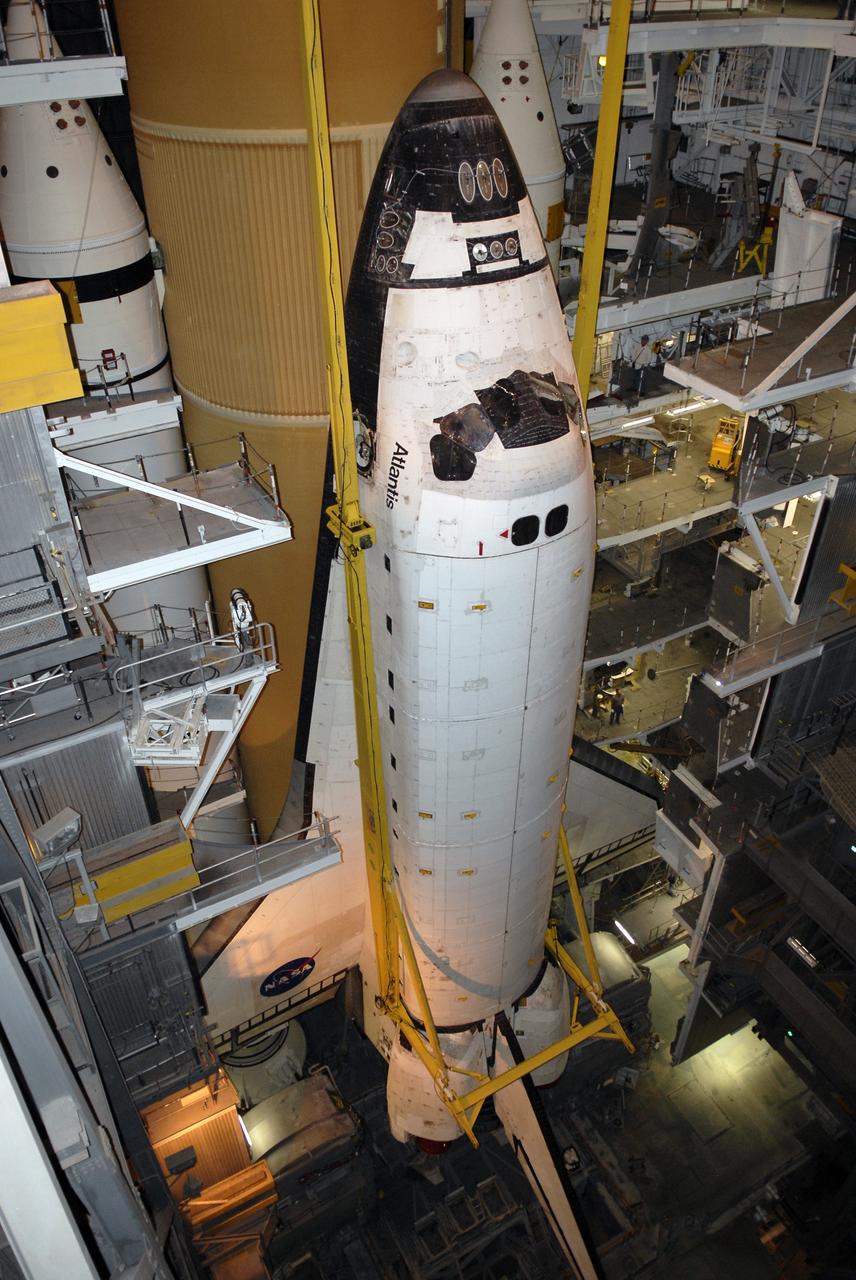 CAPE CANAVERAL, Fla. – In the Vehicle Assembly Building at NASA's Kennedy Space Center in Florida, space shuttle Atlantis is lowered alongside the external fuel tank and solid rocket boosters in High Bay 3. The shuttle will be mated with the external tank and boosters on the mobile launcher platform. After additional preparations are made, the shuttle will be rolled out to Launch Pad 39A for a targeted launch on May 12 on the STS-125 mission to service NASA's Hubble Space Telescope. Photo credit: NASA/Kim Shiflett