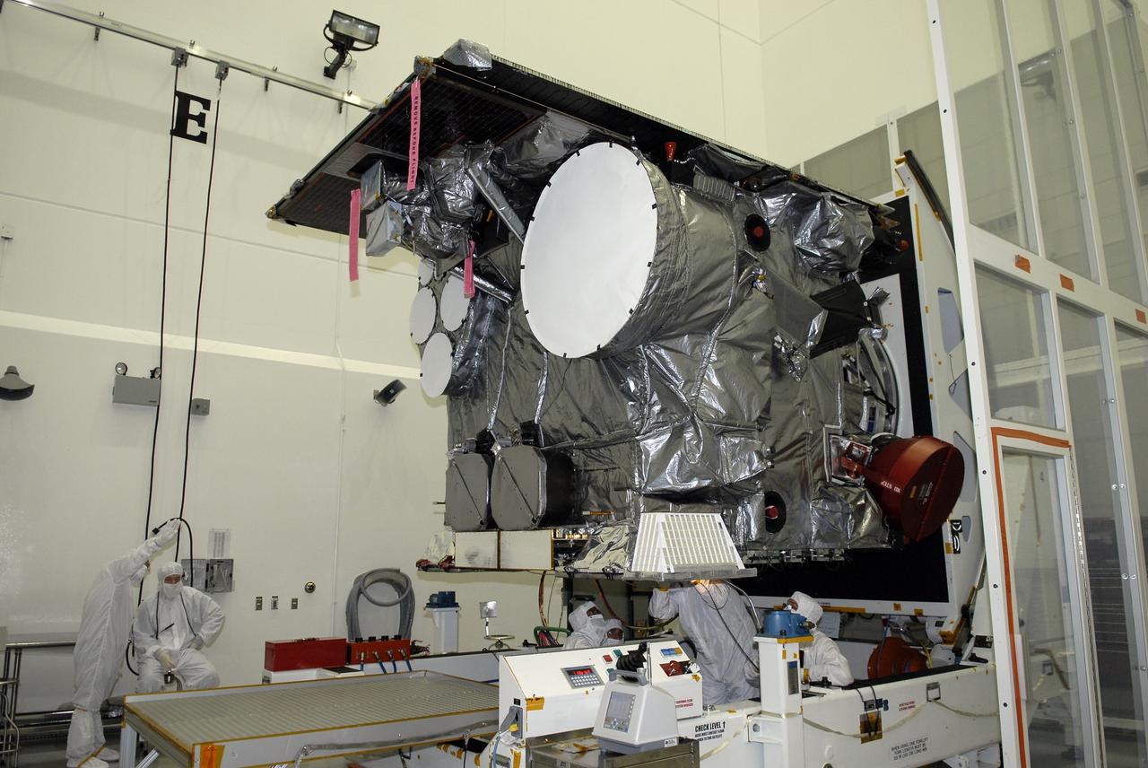 CAPE CANAVERAL, Fla. – At the Astrotech payload processing facility in Titusville, Fla., technicians complete the rotation of the GOES-O satellite on the stand. The latest Geostationary Operational Environmental Satellite, GOES-O was developed by NASA for the National Oceanic and Atmospheric Administration, or NOAA. Once in orbit, GOES-O will be designated GOES-14, and NASA will provide on-orbit checkout and then transfer operational responsibility to NOAA. The GOES-O satellite is targeted to launch April 28 onboard a United Launch Alliance Delta IV expendable launch vehicle.  Photo credit: NASA/Kim Shiflett
