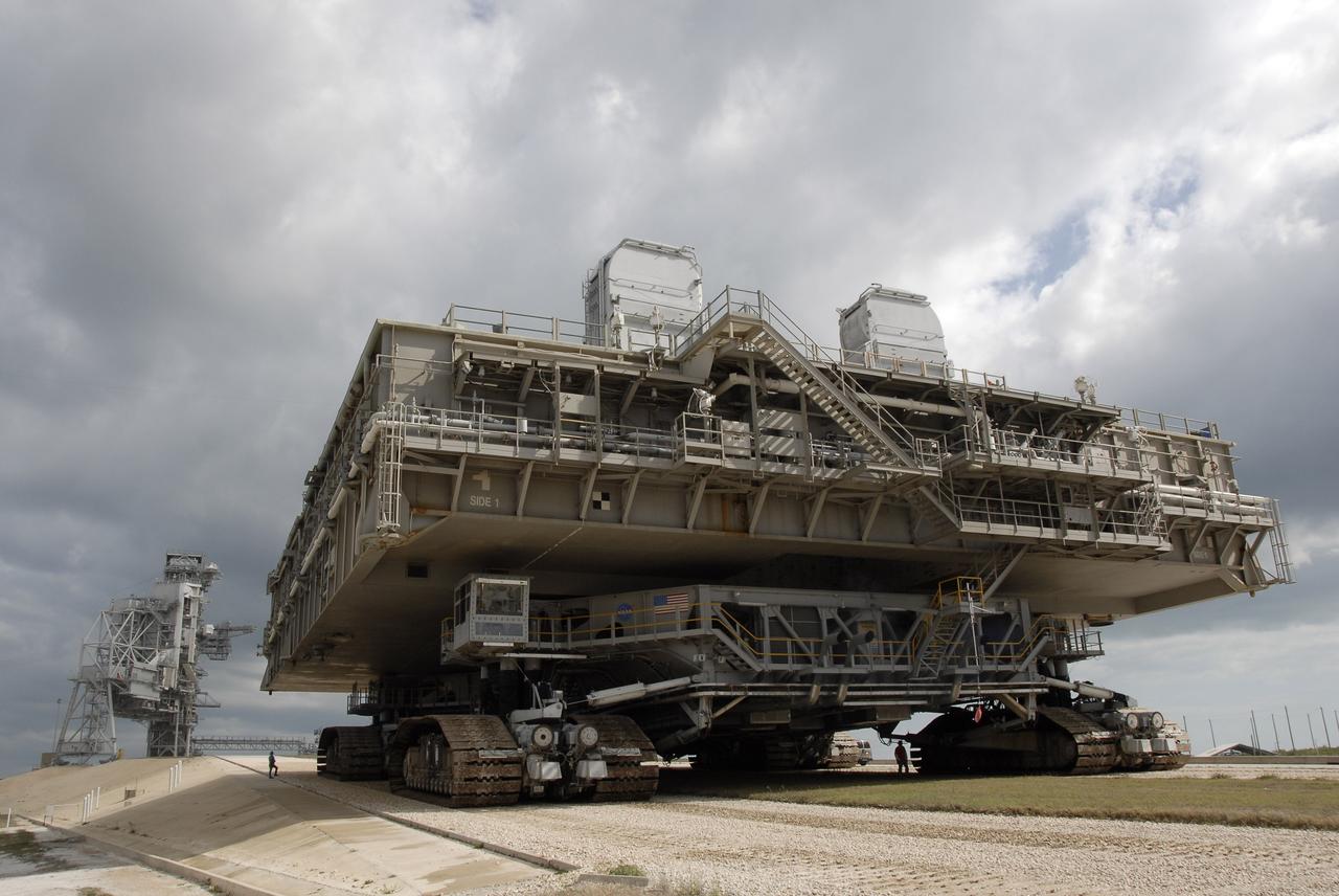 CAPE CANAVERAL, Fla. – Mobile Launcher Platform-1 is moving to Launch Pad 39B at NASA's Kennedy Space Center in Florida via the crawler-transporter underneath.  The MLP has been handed over to the Constellation Program for its future use for the Ares I-X flight test in the summer of 2009.  Ares I-X is the test vehicle for the Ares I, which is part of the Constellation Program to return men to the moon and beyond.  Ground Control System hardware was installed in MLP-1 in December 2008.  The MLP is being moved to the launch pad to check out the installed hardware with the Launch Control Center Firing Room 1 equipment, using the actual circuits that will be used when the fully stacked Ares I-X vehicle is rolled out later this year for launch. Following this testing, MLP-1 will be moved to the Vehicle Assembly Building's High Bay 3 to begin stacking, or assembling, Ares I-X.  Photo credit: NASA/Kim Shiflett