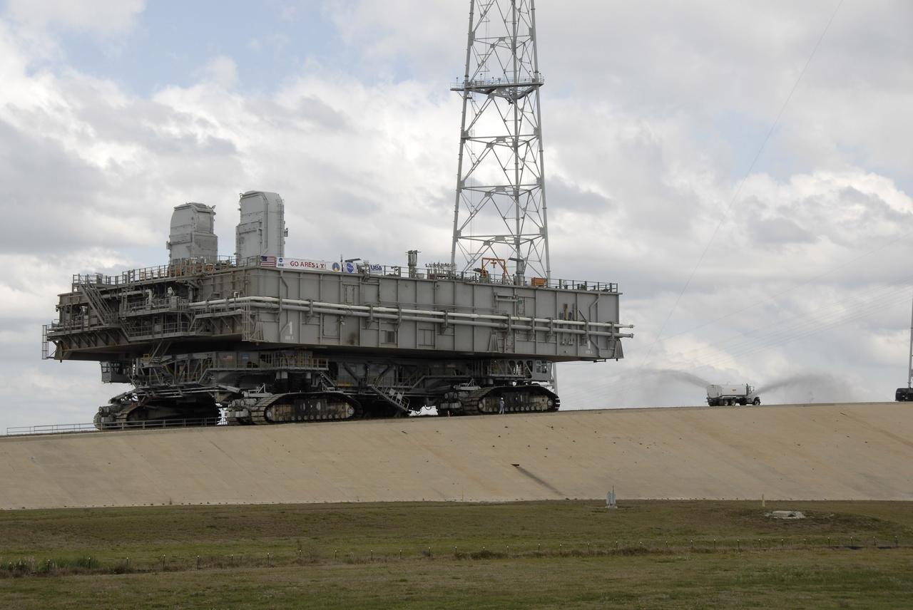 CAPE CANAVERAL, Fla. – Mobile Launcher Platform-1 nears the top of Launch Pad 39B at NASA's Kennedy Space Center in Florida via the crawler-transporter underneath.  The MLP has been handed over to the Constellation Program for its future use for the Ares I-X flight test in the summer of 2009.  Ares I-X is the test vehicle for the Ares I, which is part of the Constellation Program to return men to the moon and beyond.  Ground Control System hardware was installed in MLP-1 in December 2008.  The MLP is being moved to the launch pad to check out the installed hardware with the Launch Control Center Firing Room 1 equipment, using the actual circuits that will be used when the fully stacked Ares I-X vehicle is rolled out later this year for launch. Following this testing, MLP-1 will be moved to the Vehicle Assembly Building's High Bay 3 to begin stacking, or assembling, Ares I-X.  Photo credit: NASA/Kim Shiflett