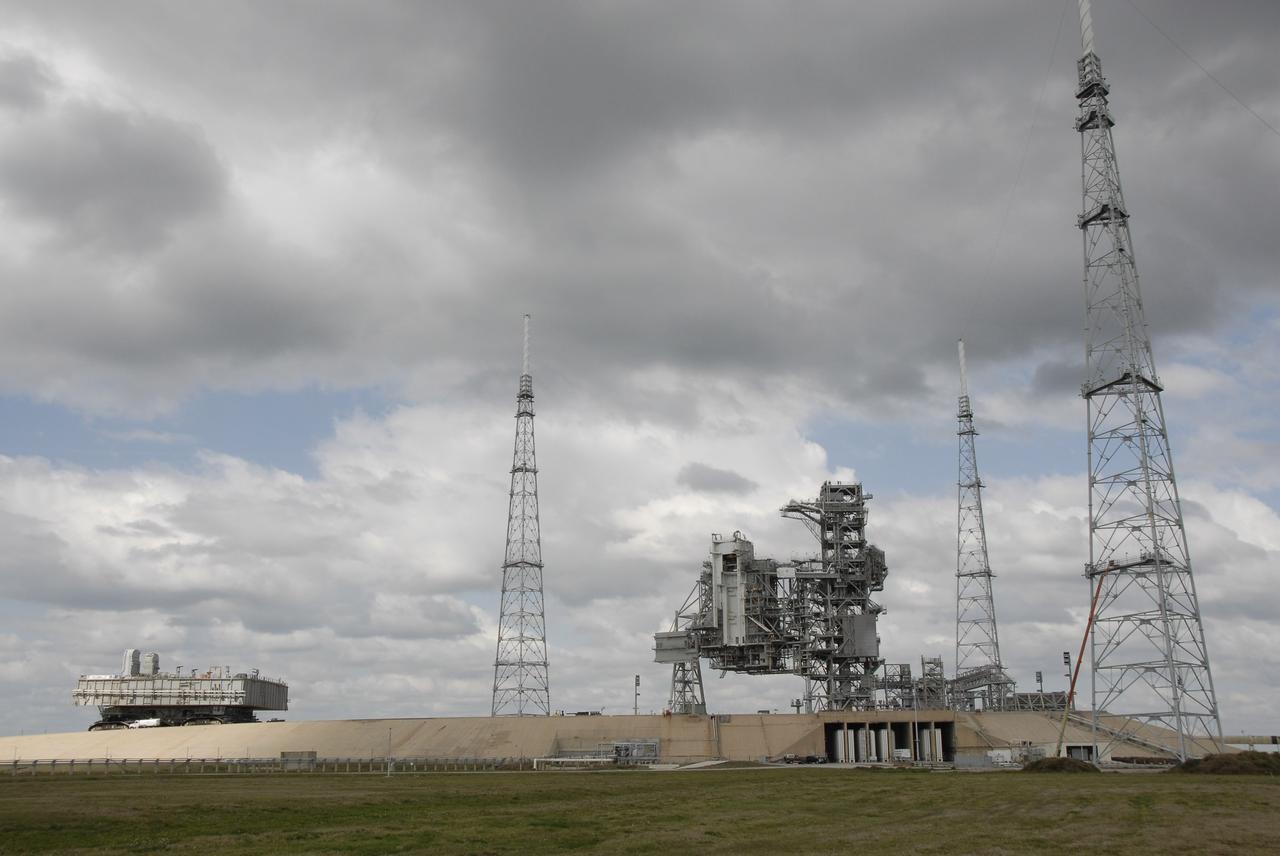CAPE CANAVERAL, Fla. – Mobile Launcher Platform-1 nears the top of Launch Pad 39B at NASA's Kennedy Space Center in Florida via the crawler-transporter underneath.  The MLP has been handed over to the Constellation Program for its future use for the Ares I-X flight test in the summer of 2009. Seen around the service structures on the pad are the new 600-foot lightning towers and masts erected for the Ares launches.  Ares I-X is the test vehicle for the Ares I, which is part of the Constellation Program to return men to the moon and beyond.  Ground Control System hardware was installed in MLP-1 in December 2008.  The MLP is being moved to the launch pad to check out the installed hardware with the Launch Control Center Firing Room 1 equipment, using the actual circuits that will be used when the fully stacked Ares I-X vehicle is rolled out later this year for launch. Following this testing, MLP-1 will be moved to the Vehicle Assembly Building's High Bay 3 to begin stacking, or assembling, Ares I-X.  Photo credit: NASA/Kim Shiflett