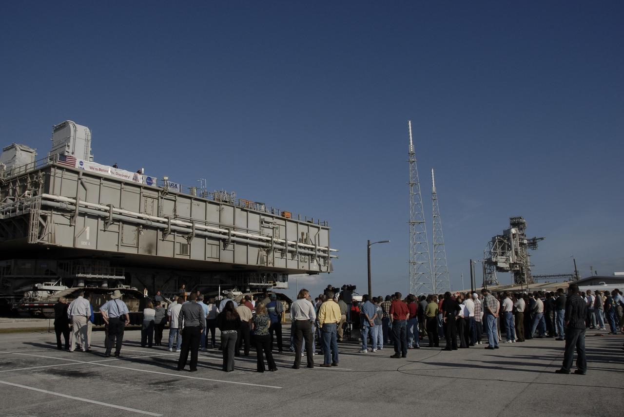 CAPE CANAVERAL, Fla. – –  Employees and media gather near Launch Pad 39B at NASA's Kennedy Space Center in Florida for the handover ceremony for Mobile Launcher Platform-1, seen here.  The platform is being transferred from NASA's Space Shuttle Program to the Constellation Program for the Ares I-X flight test targeted for this summer. Constructed in 1964, the mobile launchers used in Apollo/Saturn operations were modified for use in shuttle operations. With cranes, umbilical towers and swing arms removed, the mobile launchers were renamed Mobile Launcher Platforms, or MLPs.  Photo credit: NASA/Kim Shiflett