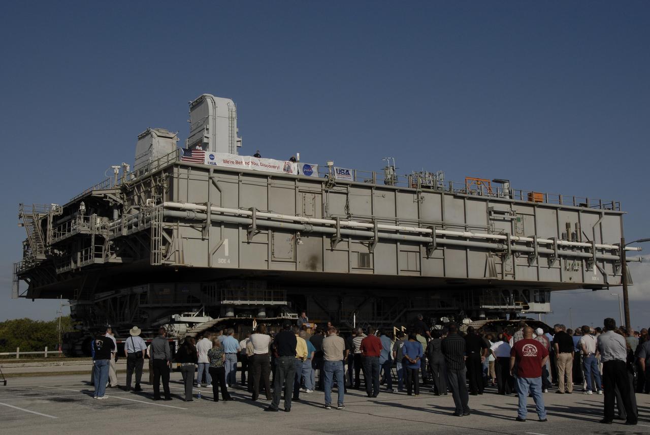 CAPE CANAVERAL, Fla. – Near Launch Pad 39B at NASA's Kennedy Space Center in Florida, employees and media gather listen to Shuttle Launch Director Mike Leinbach  during the handover ceremony for Mobile Launcher Platform-1. The platform is being transferred from NASA's Space Shuttle Program to the Constellation Program for the Ares I-X flight test targeted for this summer. Also participating in the ceremony are Rita Willcoxon, director of Launch Vehicle Processing at Kennedy, Pepper E. Phillips, director of the Constellation Project Office, and Brett Raulerson, manager of MLP Operations with United Space Alliance.  Constructed in 1964, the mobile launchers used in Apollo/Saturn operations were modified for use in shuttle operations. With cranes, umbilical towers and swing arms removed, the mobile launchers were renamed Mobile Launcher Platforms, or MLPs.  Photo credit: NASA/Kim Shiflett