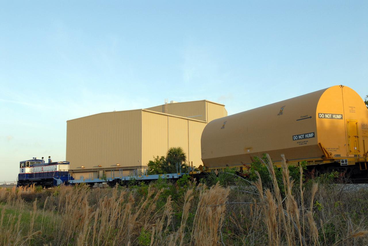 CAPE CANAVERAL, Fla. – The NASA Railroad hauls one of the cars with the first Ares I-X segment to the Rotation, Processing and Surge Facility at NASA's Kennedy Space Center in Florida. Four reusable motor segments and the nozzle exit cone, manufactured by the Ares I first-stage prime contractor Alliant Techsystems Inc.,  departed Utah March 12 on the seven-day, cross-country trip to Florida.  The segments are being delivered to Kennedy's  Rotation, Processing and Surge Facility for final processing and integration. The booster used for the Ares I-X launch is being modified by adding new forward structures and a fifth segment simulator. The motor is the final hardware needed for the rocket's upcoming test flight this summer. The stacking operations are scheduled to begin in the Vehicle Assembly Building in April.  Photo credit: NASA/Jack Pfaller