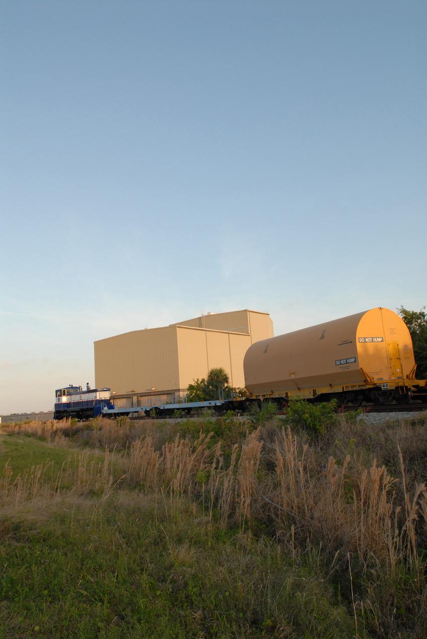 CAPE CANAVERAL, Fla. – The NASA Railroad hauls one of the cars with the first Ares I-X segment to the Rotation, Processing and Surge Facility at NASA's Kennedy Space Center in Florida. Four reusable motor segments and the nozzle exit cone, manufactured by the Ares I first-stage prime contractor Alliant Techsystems Inc.,  departed Utah March 12 on the seven-day, cross-country trip to Florida.  The segments are being delivered to Kennedy's  Rotation, Processing and Surge Facility for final processing and integration. The booster used for the Ares I-X launch is being modified by adding new forward structures and a fifth segment simulator. The motor is the final hardware needed for the rocket's upcoming test flight this summer. The stacking operations are scheduled to begin in the Vehicle Assembly Building in April.  Photo credit: NASA/Jack Pfaller