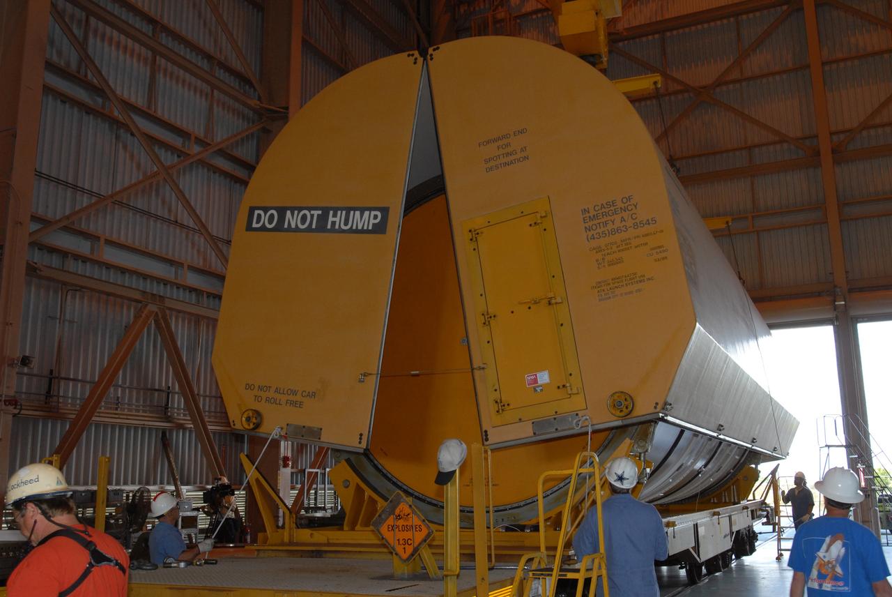 CAPE CANAVERAL, Fla. – In the Rotation, Processing and Surge Facility at NASA's Kennedy Space Center in Florida, the rail car cover is removed from the first Ares I-X motor segment.  It is one of four reusable motor segments and nozzle exit cone shipped by the Ares I first-stage prime contractor Alliant Techsystems Inc. for final processing and integration in the facility. The booster used for the Ares I-X launch is being modified by adding new forward structures and a fifth segment simulator. The motor is the final hardware needed for the rocket's upcoming flight test this summer. The stacking operations are scheduled to begin in the Vehicle Assembly Building in April. Photo credit: NASA/Jim Grossmann