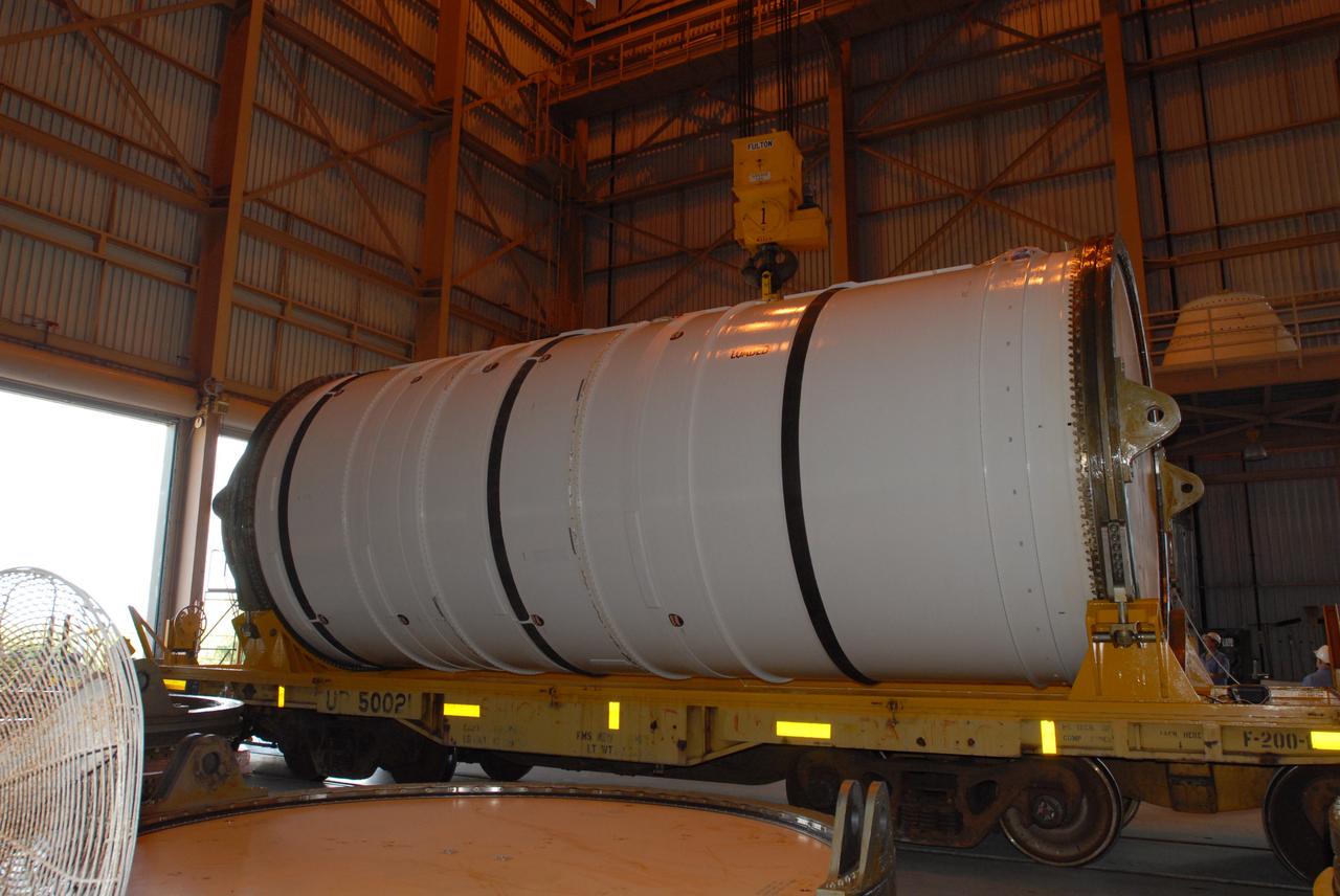 CAPE CANAVERAL, Fla. – In the Rotation, Processing and Surge Facility at NASA's Kennedy Space Center in Florida, the Ares I-X motor segment is revealed after removal of the rail car cover. It is one of four reusable motor segments and nozzle exit cone shipped by the Ares I first-stage prime contractor Alliant Techsystems Inc. for final processing and integration in the facility. The booster used for the Ares I-X launch is being modified by adding new forward structures and a fifth segment simulator. The motor is the final hardware needed for the rocket's upcoming flight test this summer. The stacking operations are scheduled to begin in the Vehicle Assembly Building in April. Photo credit: NASA/Jim Grossmann