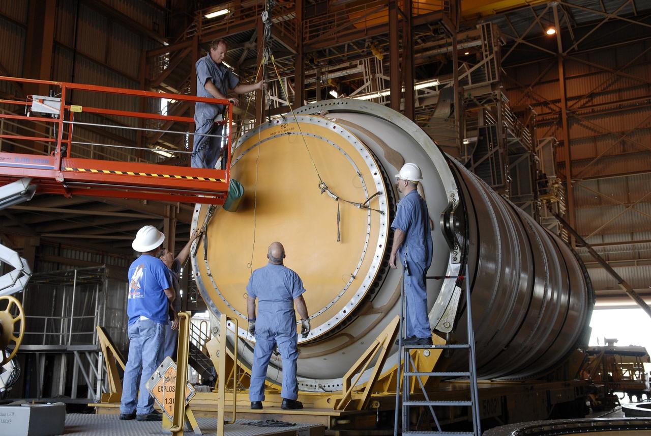 CAPE CANAVERAL, Fla. – In the Rotation, Processing and Surge Facility at NASA's Kennedy Space Center in Florida, technicians prepare to remove the cover from the end of the Ares I-X motor segment for propellant grain inspection of the interior. It is one of four reusable motor segments and nozzle exit cone shipped by the Ares I first-stage prime contractor Alliant Techsystems Inc. for final processing and integration in the facility. The booster used for the Ares I-X launch is being modified by adding new forward structures and a fifth segment simulator. The motor is the final hardware needed for the rocket's upcoming flight test this summer. The stacking operations are scheduled to begin in the Vehicle Assembly Building in April. Photo credit: NASA/Jim Grossmann