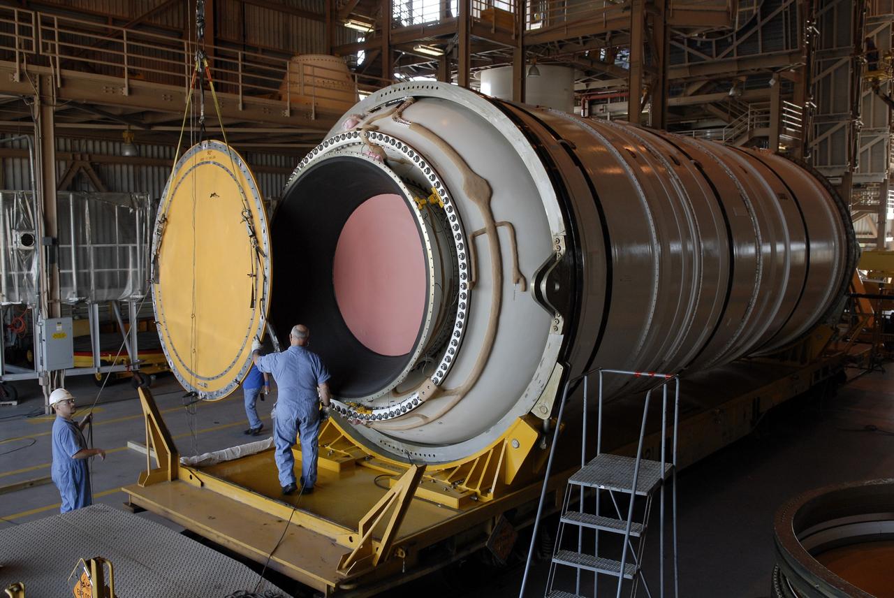 CAPE CANAVERAL, Fla. –In the Rotation, Processing and Surge Facility at NASA's Kennedy Space Center in Florida, the end of the Ares I-X motor segment is removed to allow propellant grain inspection of the interior.  It is one of four reusable motor segments and nozzle exit cone shipped by the Ares I first-stage prime contractor Alliant Techsystems Inc. for final processing and integration in the facility. The booster used for the Ares I-X launch is being modified by adding new forward structures and a fifth segment simulator. The motor is the final hardware needed for the rocket's upcoming flight test this summer. The stacking operations are scheduled to begin in the Vehicle Assembly Building in April. Photo credit: NASA/Jim Grossmann