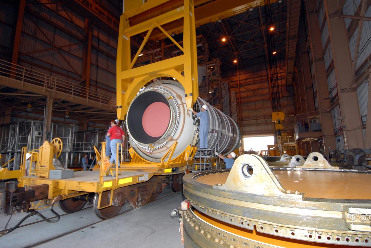 CAPE CANAVERAL, Fla. –  A crane is being attached to the first of the Ares I-X motor segments to raise it for transfer it to a work stand in the Rotation, Processing and Surge Facility at NASA's Kennedy Space Center in Florida. Four segments were delivered to Kennedy for final processing and integration. The booster used for the Ares I-X launch is being modified by adding new forward structures and a fifth segment simulator. The motor is the final hardware needed for the rocket's upcoming test flight this summer. The stacking operations are scheduled to begin in the Vehicle Assembly Building in April.  Photo credit: NASA/Jack Pfaller