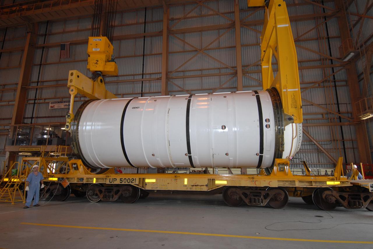 CAPE CANAVERAL, Fla. –  Cranes are attached to the first of the Ares I-X motor segments to raise and transfer it to a work stand in the Rotation, Processing and Surge Facility at NASA's Kennedy Space Center in Florida. Four segments were delivered to Kennedy for final processing and integration. The booster used for the Ares I-X launch is being modified by adding new forward structures and a fifth segment simulator. The motor is the final hardware needed for the rocket's upcoming test flight this summer. The stacking operations are scheduled to begin in the Vehicle Assembly Building in April.  Photo credit: NASA/Jack Pfaller