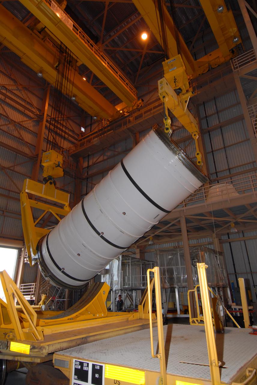 CAPE CANAVERAL, Fla. –  Cranes begin rotating the Ares I-X motor segment to a vertical position in order to transfer it to a work stand in the Rotation, Processing and Surge Facility at NASA's Kennedy Space Center in Florida.  Four segments were delivered to Kennedy for final processing and integration. The booster used for the Ares I-X launch is being modified by adding new forward structures and a fifth segment simulator. The motor is the final hardware needed for the rocket's upcoming test flight this summer. The stacking operations are scheduled to begin in the Vehicle Assembly Building in April.  Photo credit: NASA/Jack Pfaller