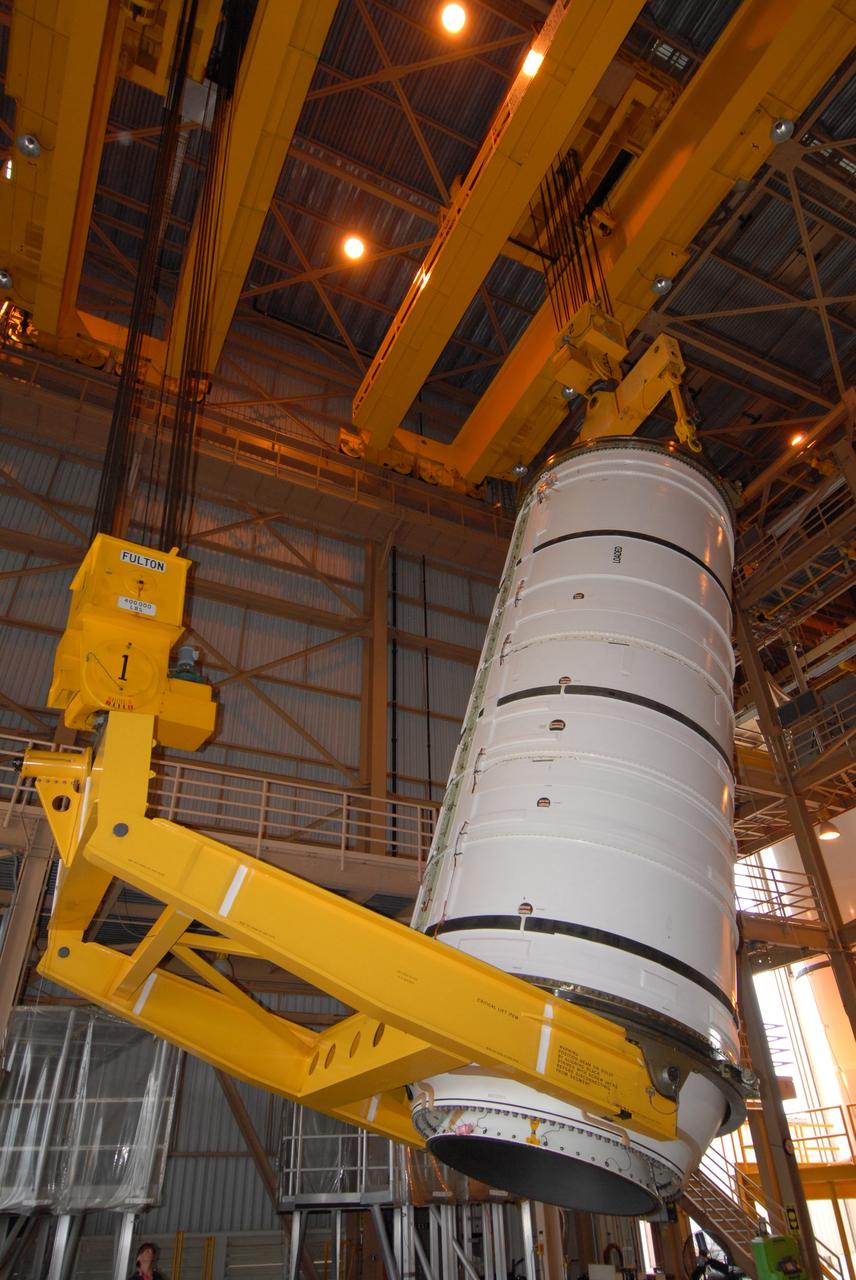 CAPE CANAVERAL, Fla. –  Cranes rotate the Ares I-X motor segment to a vertical position in order to transfer it to a work stand in the Rotation, Processing and Surge Facility at NASA's Kennedy Space Center in Florida. Four segments were delivered to Kennedy for final processing and integration. The booster used for the Ares I-X launch is being modified by adding new forward structures and a fifth segment simulator. The motor is the final hardware needed for the rocket's upcoming test flight this summer. The stacking operations are scheduled to begin in the Vehicle Assembly Building in April.  Photo credit: NASA/Jack Pfaller