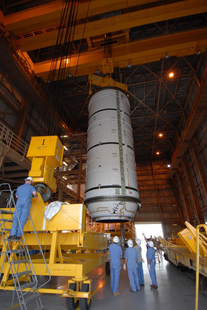 CAPE CANAVERAL, Fla. –  Technicians check the Ares I-X motor segment after its rotation to vertical. The segment will be moved to a work stand in the Rotation, Processing and Surge Facility at NASA's Kennedy Space Center in Florida. Four segments were delivered to Kennedy for final processing and integration. The booster used for the Ares I-X launch is being modified by adding new forward structures and a fifth segment simulator. The motor is the final hardware needed for the rocket's upcoming test flight this summer. The stacking operations are scheduled to begin in the Vehicle Assembly Building in April.  Photo credit: NASA/Jack Pfaller