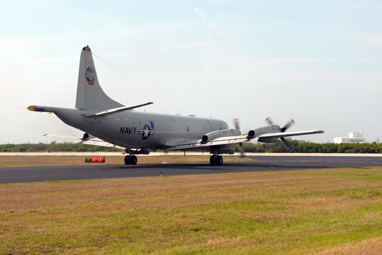 CAPE CANAVERAL, Fla. – A U.S. Navy NP-3D Orion aircraft taxies to the runway of the Skid Strip at Cape Canaveral Air Force Station in preparation for takeoff. The plane will fly below space shuttle Discovery as it approaches Kennedy Space Center for landing following the STS-119 mission. Onboard instruments will check the orbiter’s exterior temperatures and a long-range infrared camera will remotely monitor heating to the shuttle’s lower surface, part of the boundary layer transition flight experiment. For the experiment, a heat shield tile with a “speed bump” on it was installed under Discovery’s left wing to intentionally disturb the airflow in a controlled manner and make the airflow turbulent. The tile, a BRI-18, was originally developed as a potential heat shield upgrade on the orbiters and is being considered for use on the Constellation Program’s Orion crew exploration vehicles. The data will determine if a protuberance on a BRI-18 tile is safe to fly and will be used to verify and improve design efforts for future spacecraft. Photo credit: NASA/Jim Grossmann