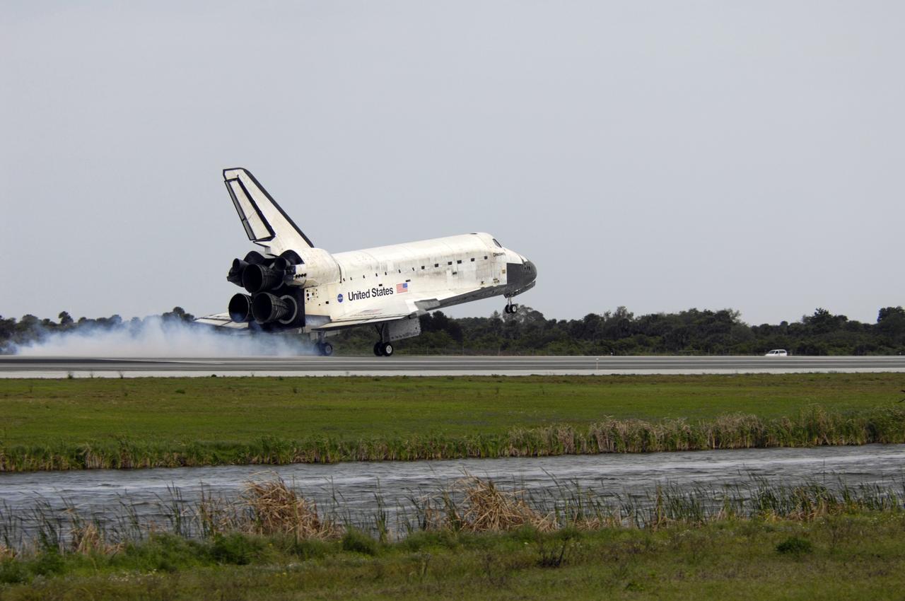 CAPE CANAVERAL, Fla. – A cloud rises from Runway 15 at NASA's Kennedy Space Center in Florida as the wheels of space shuttle Discovery contact the pavement. Landing of Discovery March 28, 2009, completed the 13-day, 5.3-million mile journey on the STS-119 mission to the International Space Station. Main gear touchdown was at 3:13:17 p.m. EDT. Nose gear touchdown was at 3:13:40 p.m. and wheels stop was at 3:14:45 p.m. Discovery delivered the final pair of large power-generating solar array wings and the S6 truss segment. The mission was the 28th flight to the station, the 36th flight of Discovery and the 125th in the Space Shuttle Program, as well as the 70th landing at Kennedy. Photo credit: NASA/Michael Kerley