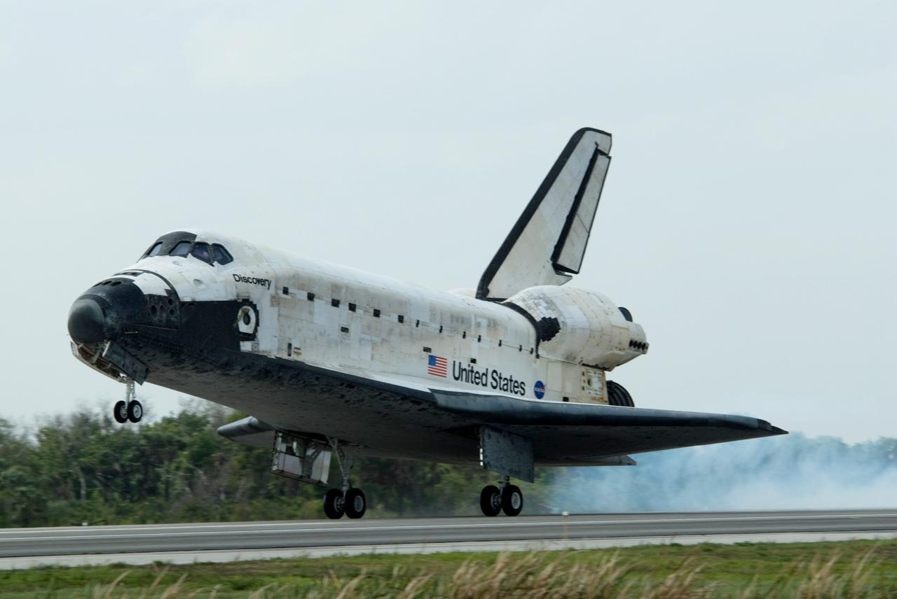 CAPE CANAVERAL, Fla. – A cloud rises from Runway 15 at NASA's Kennedy Space Center in Florida as the wheels of space shuttle Discovery contact the pavement. Landing of Discovery March 28, 2009, completed the 13-day, 5.3-million mile journey on the STS-119 mission to the International Space Station. Main gear touchdown was at 3:13:17 p.m. EDT.  Nose gear touchdown was at 3:13:40 p.m. and wheels stop was at 3:14:45 p.m.  Discovery delivered the final pair of large power-generating solar array wings and the S6 truss segment. The mission was the 28th flight to the station, the 36th flight of Discovery and the 125th in the Space Shuttle Program, as well as the 70th landing at Kennedy. Photo credit: NASA/Ben Cooper