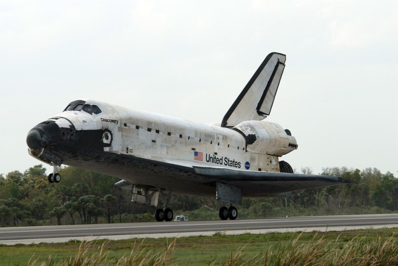 CAPE CANAVERAL, Fla. – The main landing gear of space shuttle Discovery contact the pavement on Runway 15 at NASA's Kennedy Space Center in Florida, completing the 13-day, 5.3-million mile journey on the STS-119 mission to the International Space Station. Main gear touchdown was at 3:13:17 p.m. EDT. Nose gear touchdown was at 3:13:40 p.m. and wheels stop was at 3:14:45 p.m. Discovery delivered the final pair of large power-generating solar array wings and the S6 truss segment. The mission was the 28th flight to the station, the 36th flight of Discovery and the 125th in the Space Shuttle Program, as well as the 70th landing at Kennedy. Photo credit: NASA/Ben Cooper