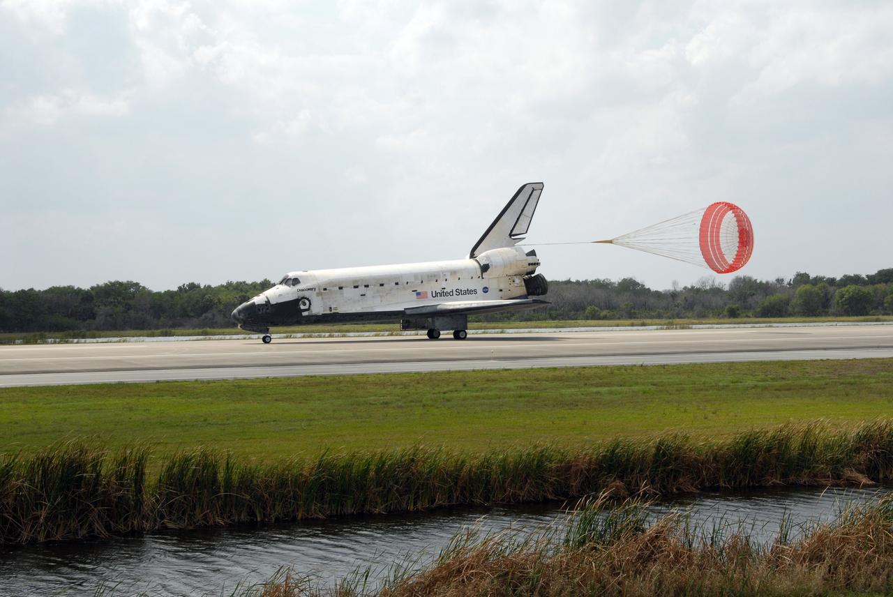 CAPE CANAVERAL, Fla. – The drogue chute unfurls behind space shuttle Discovery on Runway 15 at NASA's Kennedy Space Center in Florida. Landing of Discovery March 28, 2009, completed the 13-day, 5.3-million mile journey on the STS-119 mission to the International Space Station. Main gear touchdown was at 3:13:17 p.m. EDT. Nose gear touchdown was at 3:13:40 p.m. and wheels stop was at 3:14:45 p.m. Discovery delivered the final pair of large power-generating solar array wings and the S6 truss segment. The mission was the 28th flight to the station, the 36th flight of Discovery and the 125th in the Space Shuttle Program, as well as the 70th landing at Kennedy. Photo credit: NASA/Troy Cryder