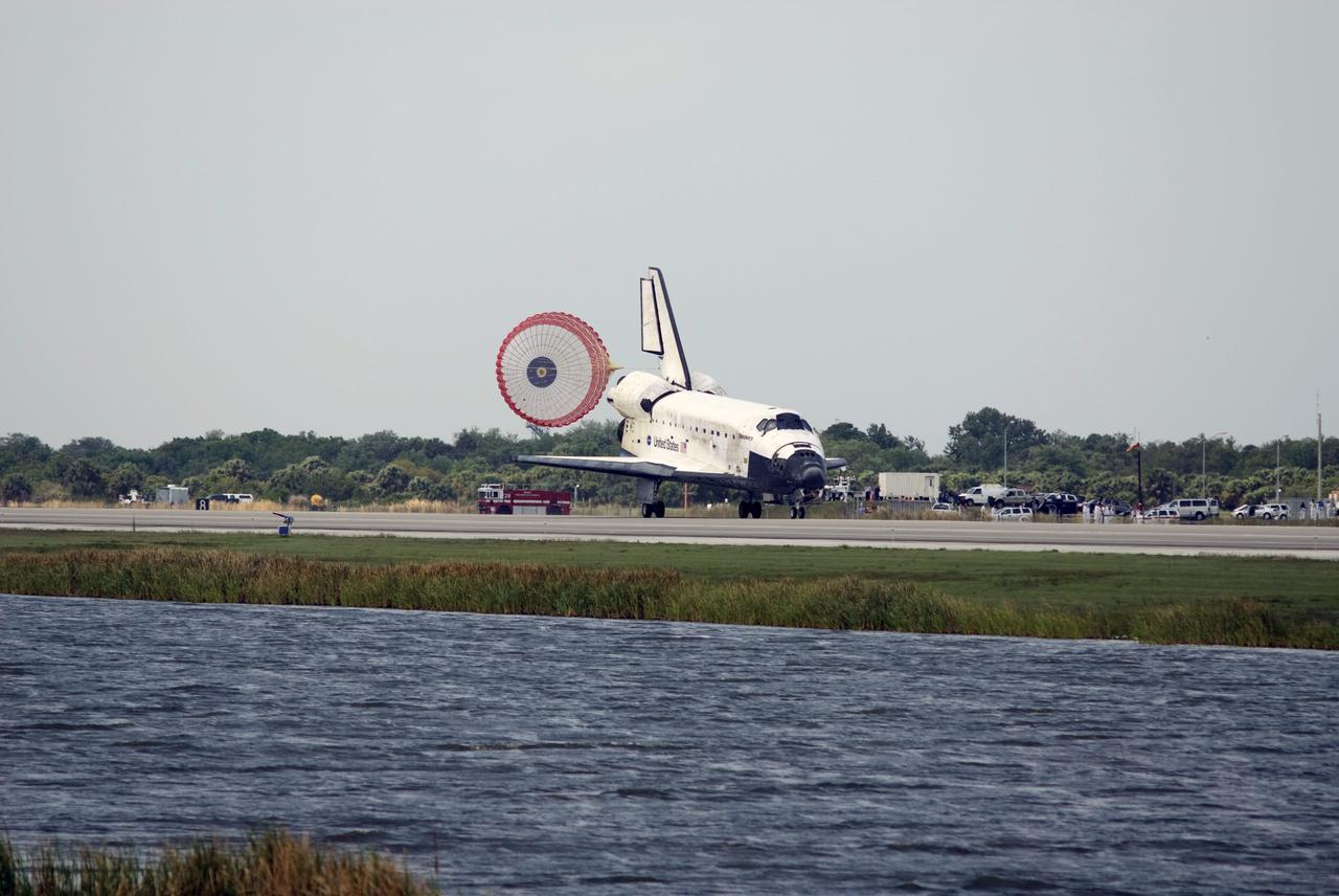 CAPE CANAVERAL, Fla. – A Fire Rescue Services vehicle stands by as the drogue chute unfurls behind space shuttle Discovery on Runway 15 at NASA's Kennedy Space Center in Florida. Landing of Discovery March 28, 2009, completed the 13-day, 5.3-million mile journey on the STS-119 mission to the International Space Station. Main gear touchdown was at 3:13:17 p.m. EDT. Nose gear touchdown was at 3:13:40 p.m. and wheels stop was at 3:14:45 p.m. Discovery delivered the final pair of large power-generating solar array wings and the S6 truss segment. The mission was the 28th flight to the station, the 36th flight of Discovery and the 125th in the Space Shuttle Program, as well as the 70th landing at Kennedy. Photo credit: NASA/Tim Powers