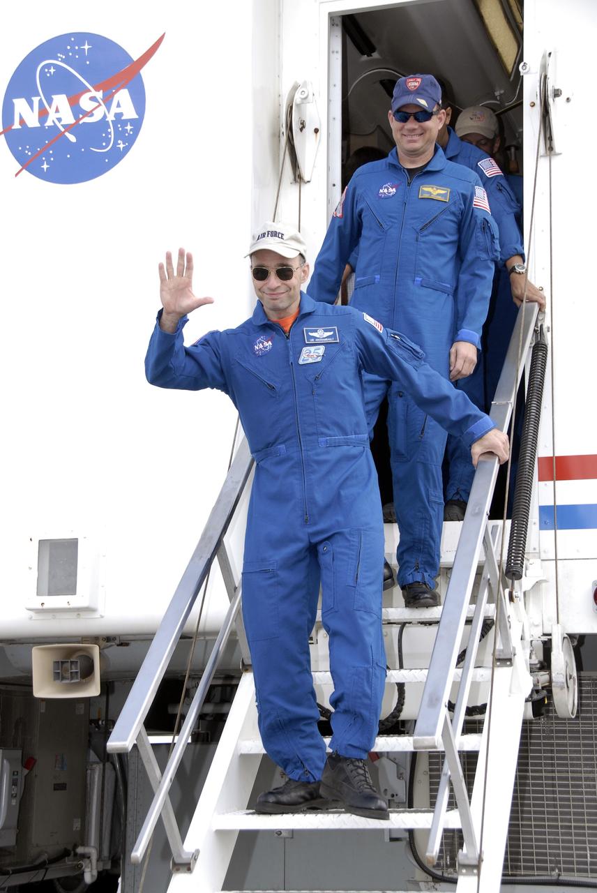 CAPE CANAVERAL, Fla. – STS-119 Commander Lee Archambault, waving, and Pilot Tony Antonelli exit the crew transport vehicle on Runway 15 at NASA's Kennedy Space Center in Florida. Space shuttle Discovery’s landing completed the 13-day, 5.3-million mile journey of the STS-119 mission to the International Space Station. Main gear touchdown was at 3:13:17 p.m. EDT. Nose gear touchdown was at 3:13:40 p.m. and wheels stop was at 3:14:45 p.m. Discovery delivered the final pair of large power-generating solar array wings and the S6 truss segment. The mission was the 28th flight to the station, the 36th flight of Discovery and the 125th in the Space Shuttle Program, as well as the 70th landing at Kennedy. Photo credit: NASA/Kim Shiflett