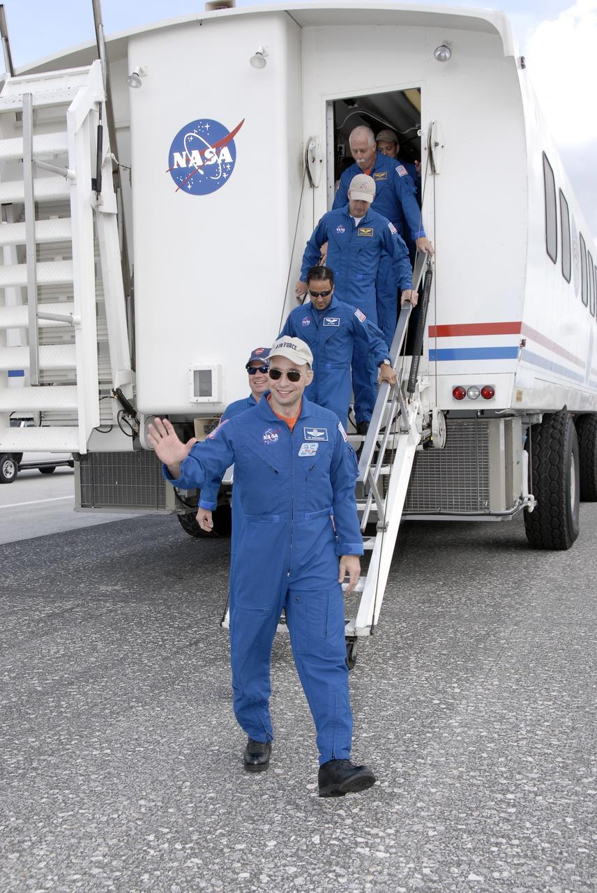 CAPE CANAVERAL, Fla. – STS-119 Commander Lee Archambault, waving, exits the crew transport vehicle on Runway 15 at NASA's Kennedy Space Center in Florida. He is followed by Pilot Tony Antonelli and Mission Specialists Joseph Acaba, Steve Swanson, John Phillips and Richard Arnold. Space shuttle Discovery’s landing completed the 13-day, 5.3-million mile journey of the STS-119 mission to the International Space Station. Main gear touchdown was at 3:13:17 p.m. EDT. Nose gear touchdown was at 3:13:40 p.m. and wheels stop was at 3:14:45 p.m. Discovery delivered the final pair of large power-generating solar array wings and the S6 truss segment. The mission was the 28th flight to the station, the 36th flight of Discovery and the 125th in the Space Shuttle Program, as well as the 70th landing at Kennedy. Photo credit: NASA/Kim Shiflett