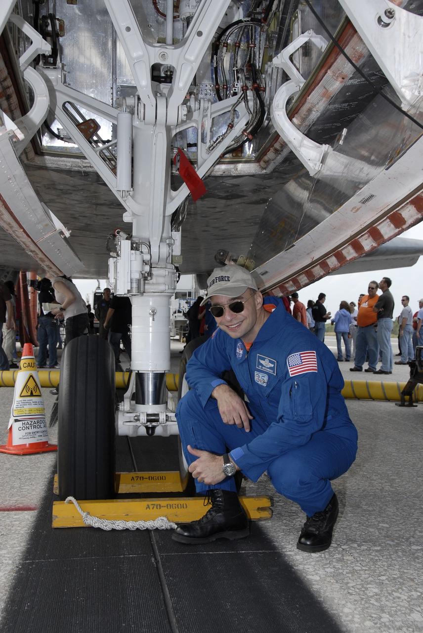 CAPE CANAVERAL, Fla. – STS-119 Commander Lee Archambault kneels beside the nose gear of space shuttle Discovery on Runway 15 at NASA's Kennedy Space Center in Florida. Discovery’s landing completed the 13-day, 5.3-million mile journey of the STS-119 mission to the International Space Station. Main gear touchdown was at 3:13:17 p.m. EDT. Nose gear touchdown was at 3:13:40 p.m. and wheels stop was at 3:14:45 p.m. Discovery delivered the final pair of large power-generating solar array wings and the S6 truss segment. The mission was the 28th flight to the station, the 36th flight of Discovery and the 125th in the Space Shuttle Program, as well as the 70th landing at Kennedy. Photo credit: NASA/Kim Shiflett
