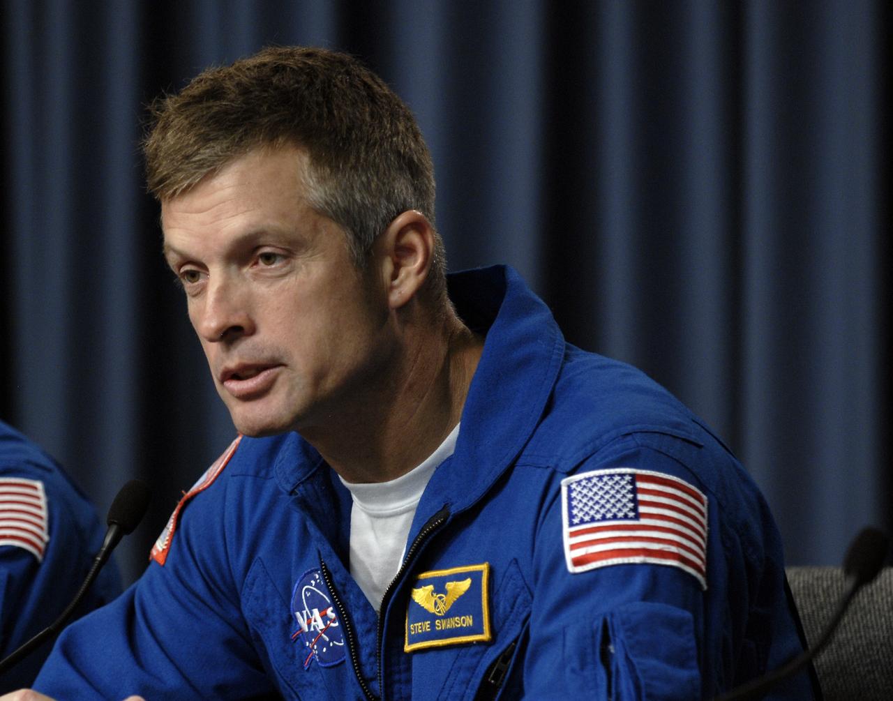 CAPE CANAVERAL, Fla. – At NASA's Kennedy Space Center in Florida, STS-119 Mission Specialist Steve Swanson answers a question from the media during a news conference following landing of the space shuttle Discovery STS-119 mission to the International Space Station. Main gear touchdown was at 3:13:17 p.m. EDT. Nose gear touchdown was at 3:13:40 p.m. and wheels stop was at 3:14:45 p.m. Discovery delivered the final pair of large power-generating solar array wings and the S6 truss segment. The mission was the 28th flight to the station, the 36th flight of Discovery and the 125th in the Space Shuttle Program, as well as the 70th landing at Kennedy. Photo credit: NASA/Kim Shiflett