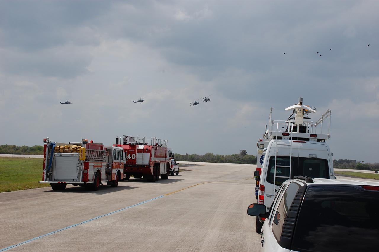 CAPE CANAVERAL, Fla. – The landing convoy arrives at the Shuttle Landing Facility runway at NASA's Kennedy Space Center in Florida.  The convoy awaits space shuttle Discovery's landing, after completing its 13-day journey of more than 5.3 million miles on the STS-119 mission. The landing convoy's purpose is to safe the vehicle and provide support for the disembarking crew and experiments.  The STS-119 flight delivered the space station's fourth and final set of large solar array wings and the S6 truss segment, completing the station's truss, or backbone. The additional electricity provided by the arrays will fully power science experiments and help support six-person station operations in May. The mission was the 28th flight to the station, the 36th flight of Discovery and the 125th in the Space Shuttle Program, as well as the 70th landing at Kennedy.  Photo credit: NASA/Ben Smegelsky