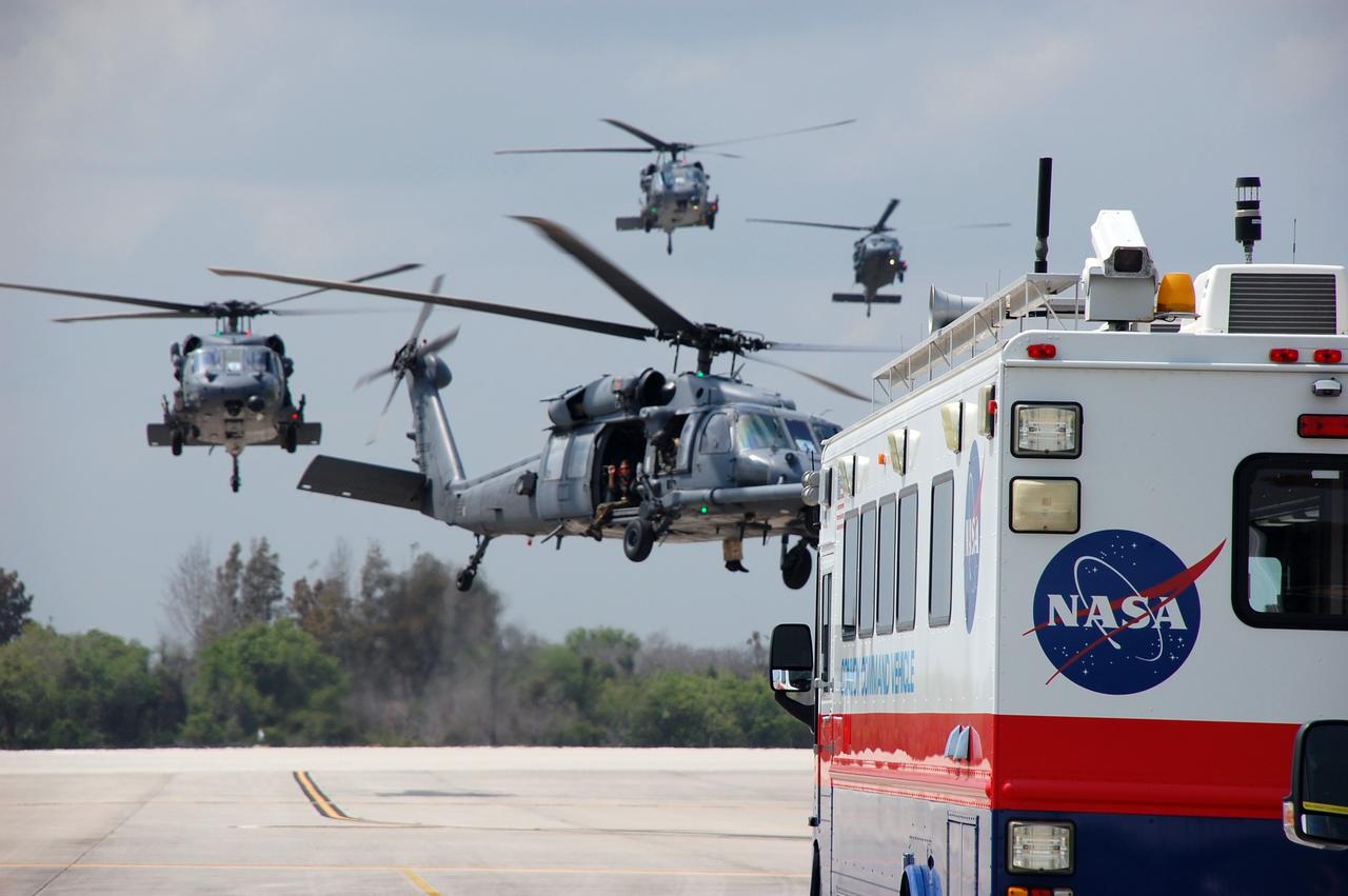 CAPE CANAVERAL, Fla. – Helicopters with medical personnel arrive at the Shuttle Landing Facility at NASA's Kennedy Space Center in Florida before space shuttle Discovery's landing.  Discovery returned from a 13-day journey of more than 5.3 million miles on the STS-119 mission.  The STS-119 flight delivered the space station's fourth and final set of large solar array wings and the S6 truss segment, completing the station's truss, or backbone. The additional electricity provided by the arrays will fully power science experiments and help support six-person station operations in May. The mission was the 28th flight to the station, the 36th flight of Discovery and the 125th in the Space Shuttle Program, as well as the 70th landing at Kennedy.  Photo credit: NASA/Ben Smegelsky