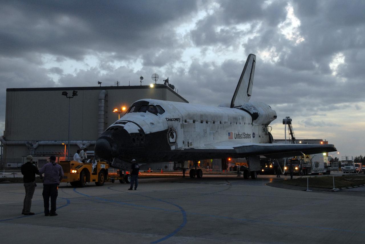 CAPE CANAVERAL, Fla. – Surrounding lights cast a glow as space shuttle Discovery is towed to Orbiter Processing Facility 3 at NASA's Kennedy Space Center in Florida. Discovery landed at 3:13:17 p.m. EDT after completing a 13-day journey of more than 5.3 million miles on the STS-119 mission. The mission was the 28th flight to the station, the 36th flight of Discovery and the 125th in the Space Shuttle Program, as well as the 70th landing at Kennedy. Photo credit: NASA/Jack Pfaller