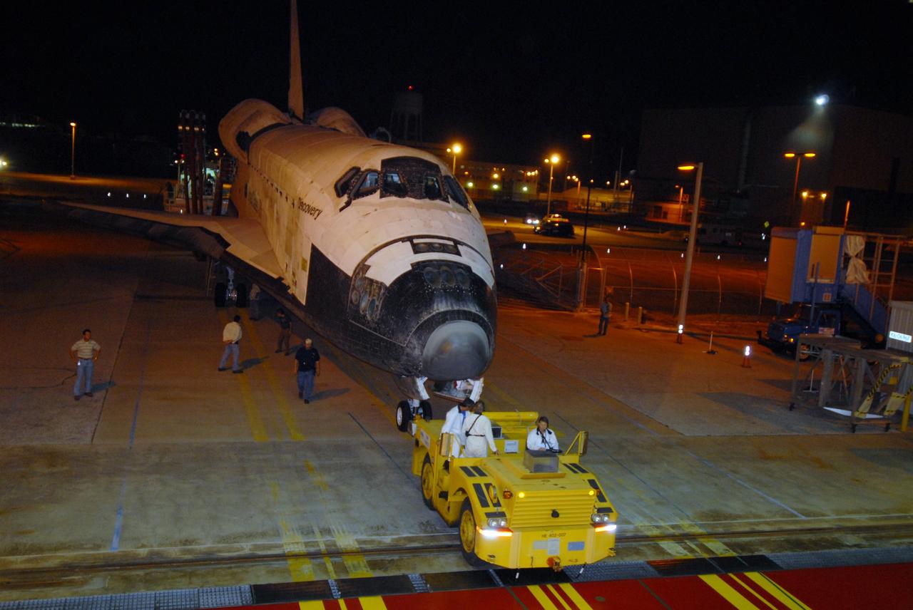 CAPE CANAVERAL, Fla. – Space shuttle Discovery is towed into Orbiter Processing Facility 3 at NASA's Kennedy Space Center in Florida. Discovery landed at 3:13:17 p.m. EDT after completing a 13-day journey of more than 5.3 million miles on the STS-119 mission. The mission was the 28th flight to the station, the 36th flight of Discovery and the 125th in the Space Shuttle Program, as well as the 70th landing at Kennedy. Photo credit: NASA/Jack Pfaller