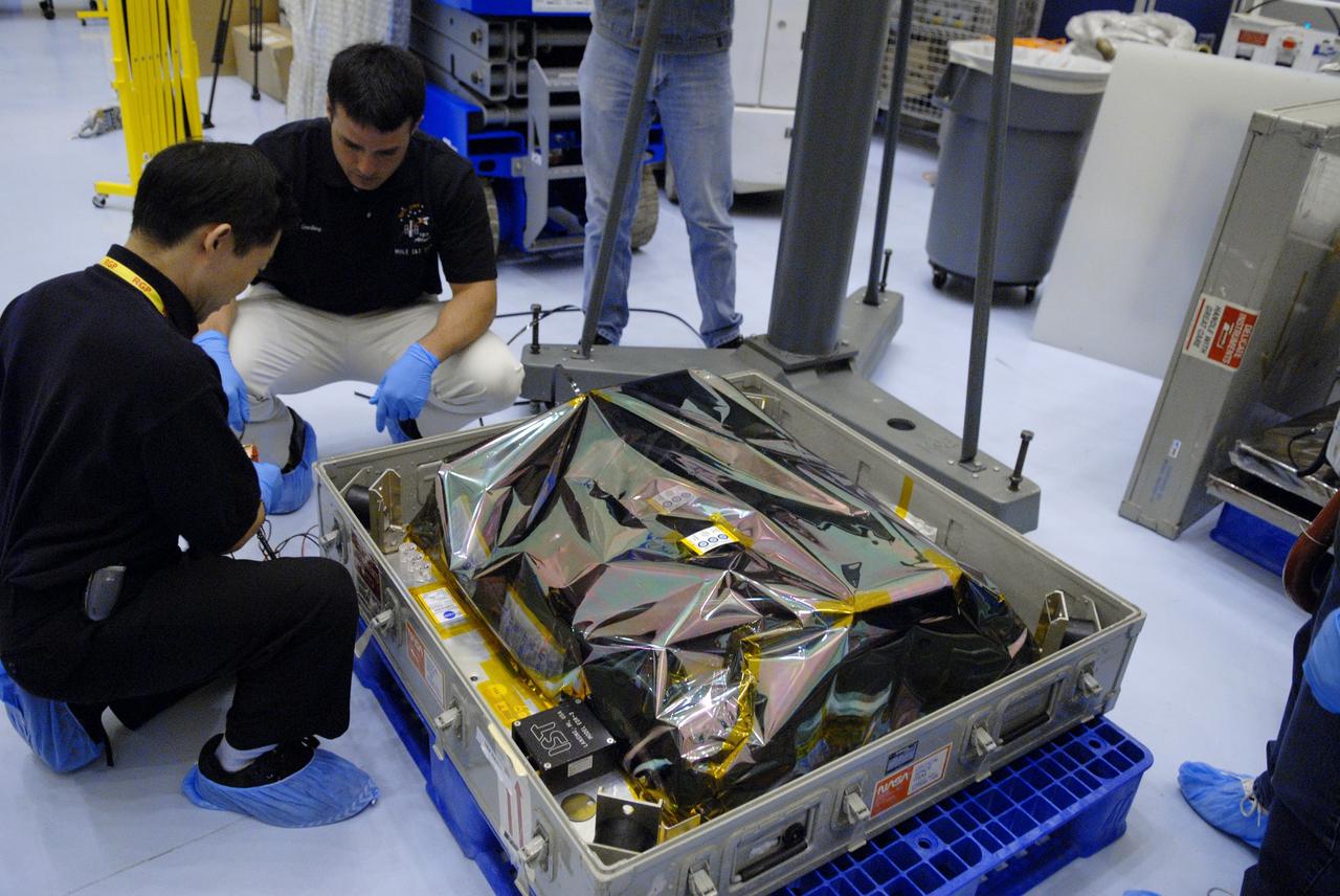 CAPE CANAVERAL, Fla. – In the Payload Hazardous Servicing Facility at NASA's Kennedy Space Center in Florida, technicians remove the shipping cover from the Science Instrument Command and Data Handling Unit, or SIC&DH.  The SIC&DH will be installed on the Hubble Space Telescope during space shuttle Atlantis' STS-125 mission. This unit will replace the one that suffered a failure aboard the orbiting telescope on Sept. 27, 2008.  The SIC&DH is being prepared for integration onto the Multi-Use Lightweight Equipment Carrier .The carrier holds the payload for space shuttle Atlantis' STS-125 mission servicing NASA's Hubble Space Telescope, targeted to launch May 12.  Photo credit: NASA/Jack Pfaller