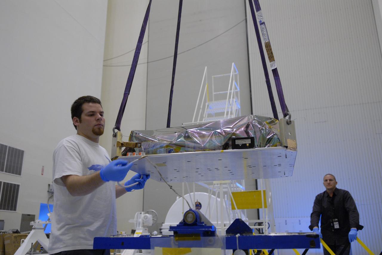 CAPE CANAVERAL, Fla. – In the Payload Hazardous Servicing Facility at NASA's Kennedy Space Center in Florida, a technician helps with the lifting of the Science Instrument Command and Data Handling Unit, or SIC&DH.  The unit will be placed on a stand until it is installed on the Multi-Use Lightweight Equipment Carrier. The SIC&DH will be installed on the Hubble Space Telescope during space shuttle Atlantis' STS-125 mission, replacing one that suffered a failure aboard the orbiting telescope on Sept. 27, 2008. The carrier holds the payload for space shuttle Atlantis' STS-125 mission servicing NASA's Hubble Space Telescope, targeted to launch May 12.  Photo credit: NASA/Jack Pfaller