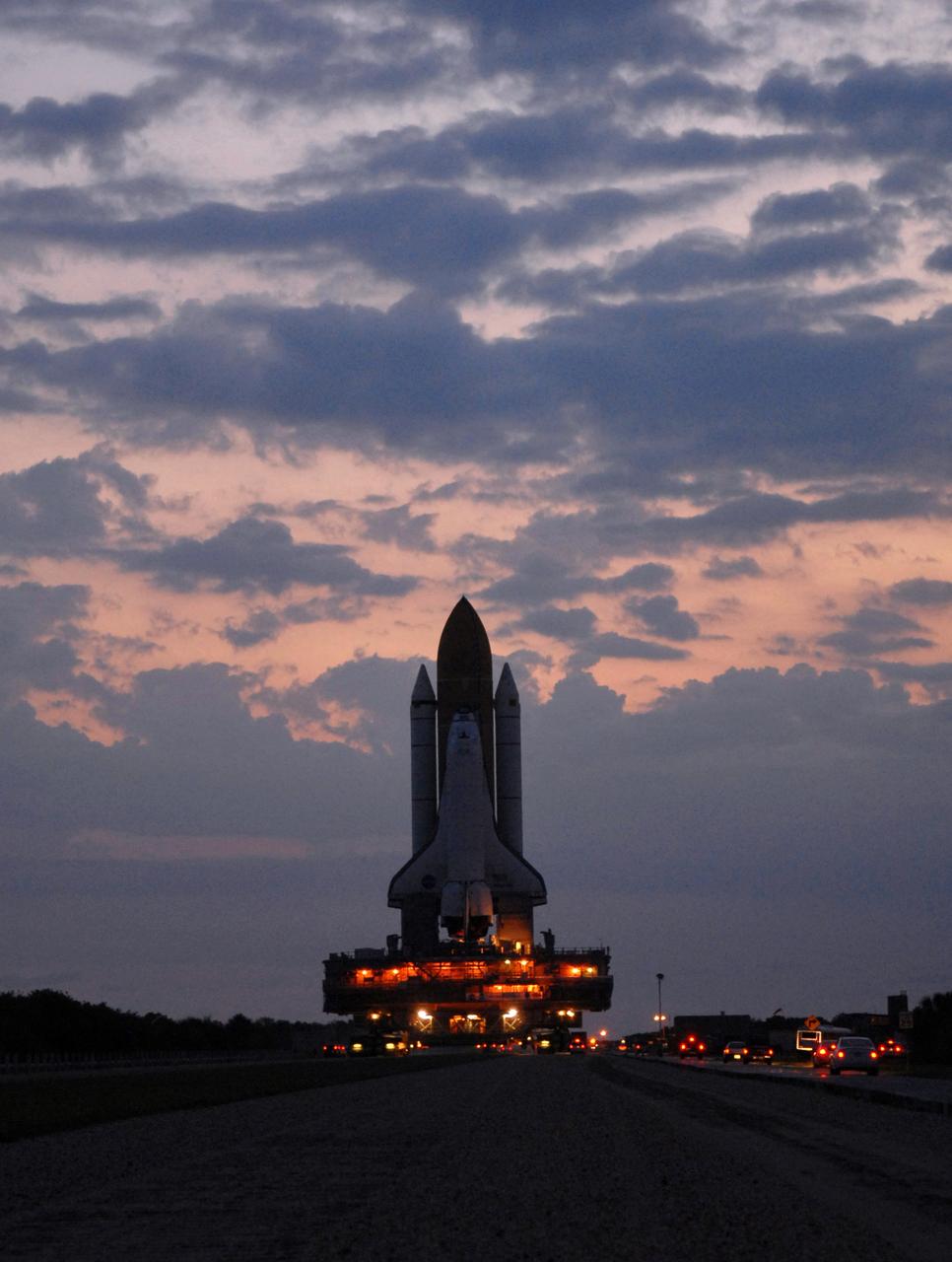 CAPE CANAVERAL, Fla. – In the early morning hours, space shuttle Atlantis rolls out to Launch Pad 39A at NASA's Kennedy Space Center in Florida after rollout from the Vehicle Assembly Building.  The shuttle sits atop the mobile launcher platform, which is carried by the crawler-transporter beneath. First motion was at 3:54 a.m. EDT and Atlantis was secured on the pad at 11:17 a.m. The 3.4-mile trip took about seven-and-a-half hours. Atlantis is targeted to lift off May 12 to service NASA's Hubble Space Telescope. During Atlantis' 11-day mission, the crew of seven astronauts will make the final shuttle flight to Hubble. During five spacewalks, they will install two new instruments, repair two inactive ones and replace components. The result will be six working, complementary science instruments with capabilities beyond what is now available, and an extended operational lifespan for the telescope through at least 2014.   Photo credit: NASA/Jack Pfaller
