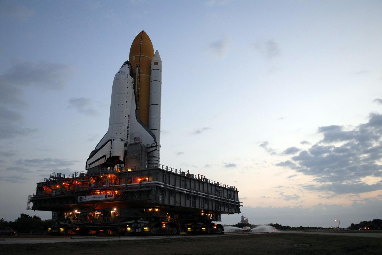 CAPE CANAVERAL, Fla. – Under early morning light, space shuttle Atlantis makes its slow way to Launch Pad 39A at NASA's Kennedy Space Center in Florida after rollout from the Vehicle Assembly Building. The shuttle sits atop the mobile launcher platform, which is carried by the crawler-transporter beneath. First motion was at 3:54 a.m. EDT and Atlantis was secured on the pad at 11:17 a.m. The 3.4-mile trip took about seven-and-a-half hours. Atlantis is targeted to lift off May 12 to service NASA's Hubble Space Telescope. During Atlantis' 11-day mission, the crew of seven astronauts will make the final shuttle flight to Hubble. During five spacewalks, they will install two new instruments, repair two inactive ones and replace components. The result will be six working, complementary science instruments with capabilities beyond what is now available, and an extended operational lifespan for the telescope through at least 2014.   Photo credit: NASA/Jack Pfaller
