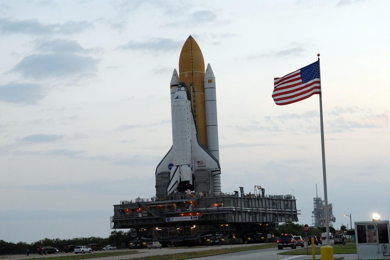 CAPE CANAVERAL, Fla. – Space shuttle Atlantis passes through the gate at Launch Pad 39A at NASA's Kennedy Space Center in Florida after rollout from the Vehicle Assembly Building.  Behind the flag pole can be seen the fixed and rotating service structures on the pad mound. The shuttle sits atop the mobile launcher platform, which is carried by the crawler-transporter beneath. First motion was at 3:54 a.m. EDT and Atlantis was secured on the pad at 11:17 a.m. The 3.4-mile trip took about seven-and-a-half hours. Atlantis is targeted to lift off May 12 to service NASA's Hubble Space Telescope. During Atlantis' 11-day mission, the crew of seven astronauts will make the final shuttle flight to Hubble. During five spacewalks, they will install two new instruments, repair two inactive ones and replace components. The result will be six working, complementary science instruments with capabilities beyond what is now available, and an extended operational lifespan for the telescope through at least 2014.   Photo credit: NASA/Jack Pfaller
