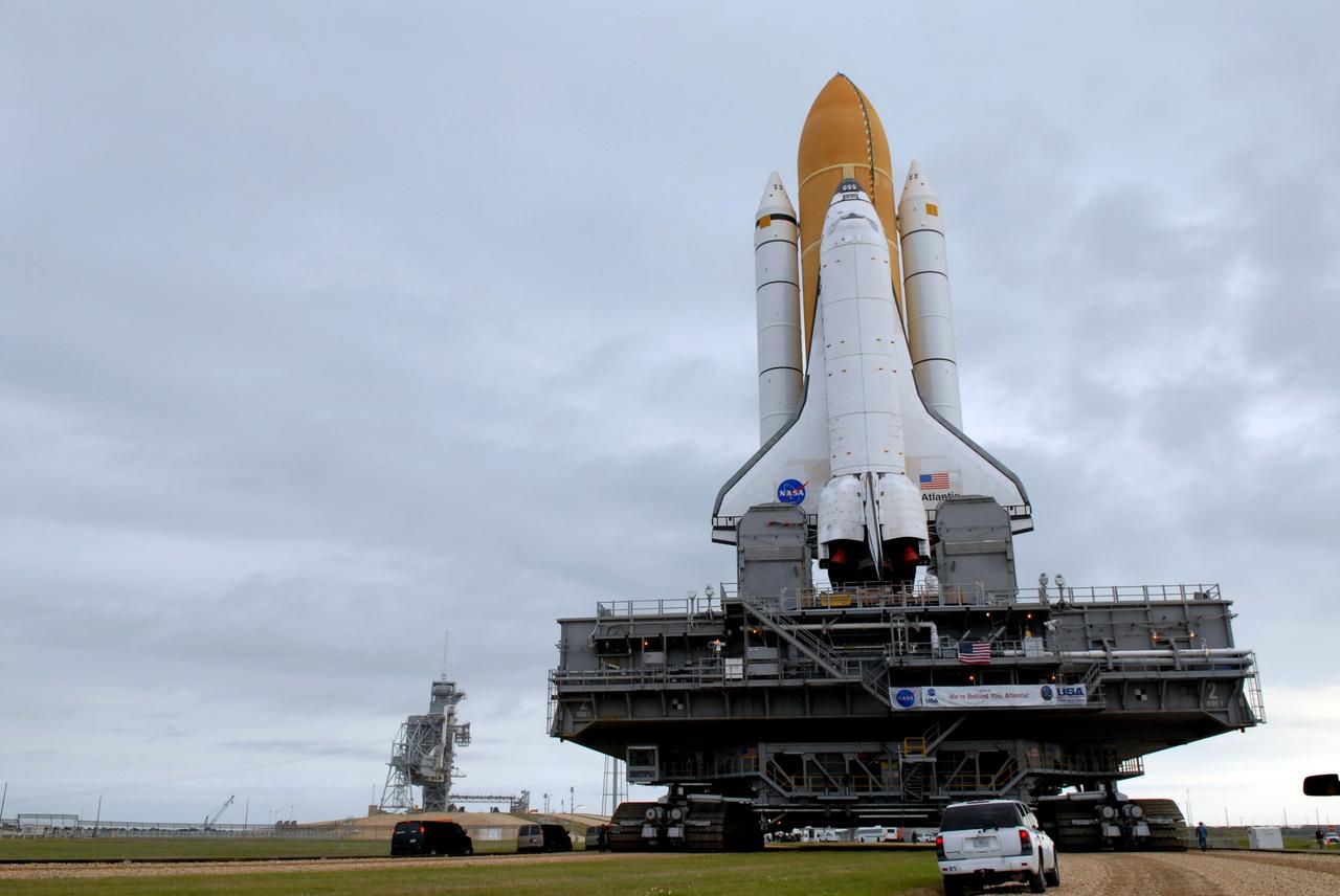 CAPE CANAVERAL, Fla. – Under cloudy skies, space shuttle Atlantis slowly makes its way to Launch Pad 39A at NASA's Kennedy Space Center in Florida after rollout from the Vehicle Assembly Building. The shuttle sits atop the mobile launcher platform, which is carried by the crawler-transporter beneath. First motion was at 3:54 a.m. EDT and Atlantis was secured on the pad at 11:17 a.m. The 3.4-mile trip took about seven-and-a-half hours. Atlantis is targeted to lift off May 12 to service NASA's Hubble Space Telescope. During Atlantis' 11-day mission, the crew of seven astronauts will make the final shuttle flight to Hubble. During five spacewalks, they will install two new instruments, repair two inactive ones and replace components. The result will be six working, complementary science instruments with capabilities beyond what is now available, and an extended operational lifespan for the telescope through at least 2014.   Photo credit: NASA/Jack Pfaller