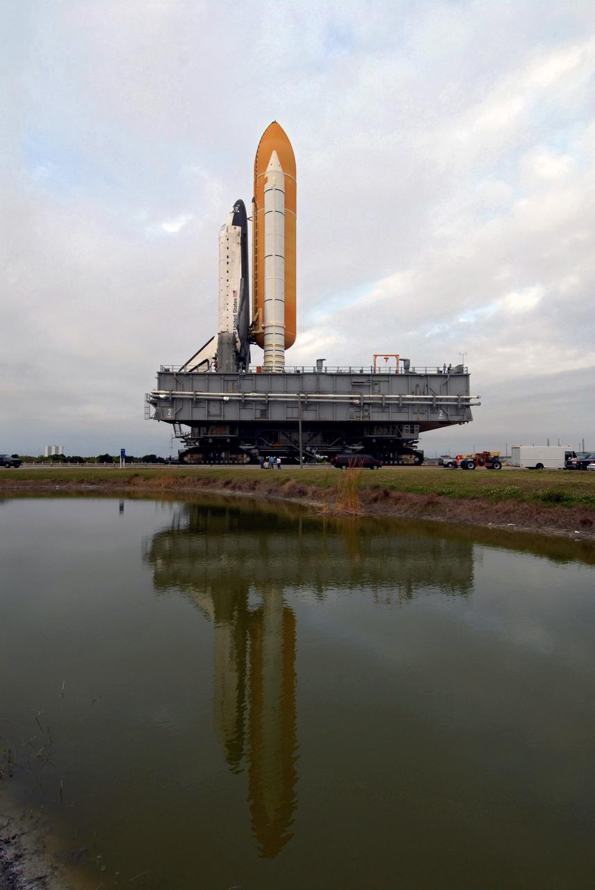 CAPE CANAVERAL, Fla. – After rollout from the Vehicle Assembly Building at NASA's Kennedy Space Center in Florida, the turn basin captures the image of space shuttle Atlantis as it travels the crawlerway to Launch Pad 39A.  The shuttle sits atop the mobile launcher platform, which is carried by the crawler-transporter beneath. First motion was at 3:54 a.m. EDT and Atlantis was secured on the pad at 11:17 a.m. The 3.4-mile trip took about seven-and-a-half hours. Atlantis is targeted to lift off May 12 to service NASA's Hubble Space Telescope. During Atlantis' 11-day mission, the crew of seven astronauts will make the final shuttle flight to Hubble. During five spacewalks, they will install two new instruments, repair two inactive ones and replace components. The result will be six working, complementary science instruments with capabilities beyond what is now available, and an extended operational lifespan for the telescope through at least 2014.   Photo credit: NASA/Jack Pfaller