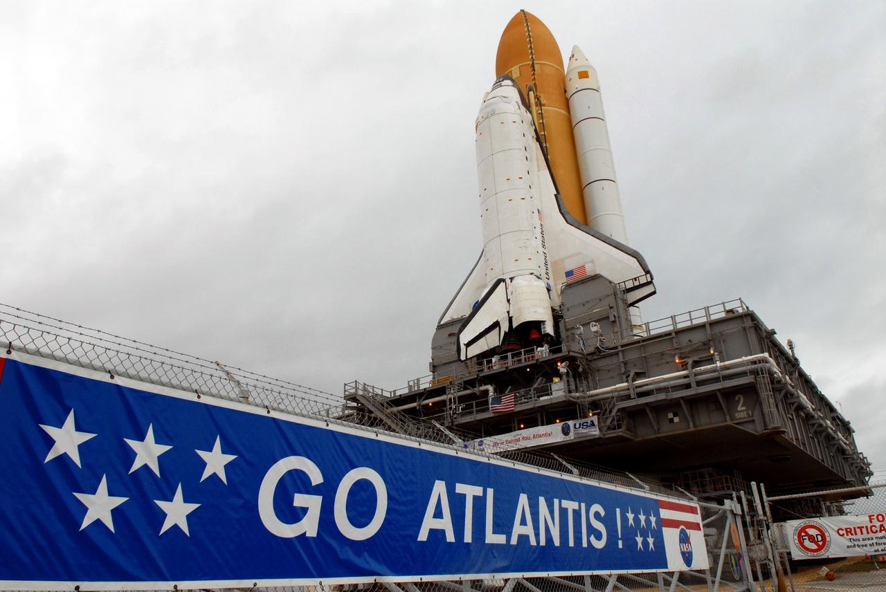 CAPE CANAVERAL, Fla. – The gate to Launch Pad 39A at NASA's Kennedy Space Center in Florida welcomes space shuttle Atlantis onto the pad mound after rollout from the Vehicle Assembly Building.  The shuttle sits atop the mobile launcher platform, which is carried by the crawler-transporter beneath. First motion was at 3:54 a.m. EDT and Atlantis was secured on the pad at 11:17 a.m. The 3.4-mile trip took about seven-and-a-half hours. Atlantis is targeted to lift off May 12 to service NASA's Hubble Space Telescope. During Atlantis' 11-day mission, the crew of seven astronauts will make the final shuttle flight to Hubble. During five spacewalks, they will install two new instruments, repair two inactive ones and replace components. The result will be six working, complementary science instruments with capabilities beyond what is now available, and an extended operational lifespan for the telescope through at least 2014.   Photo credit: NASA/Jack Pfaller