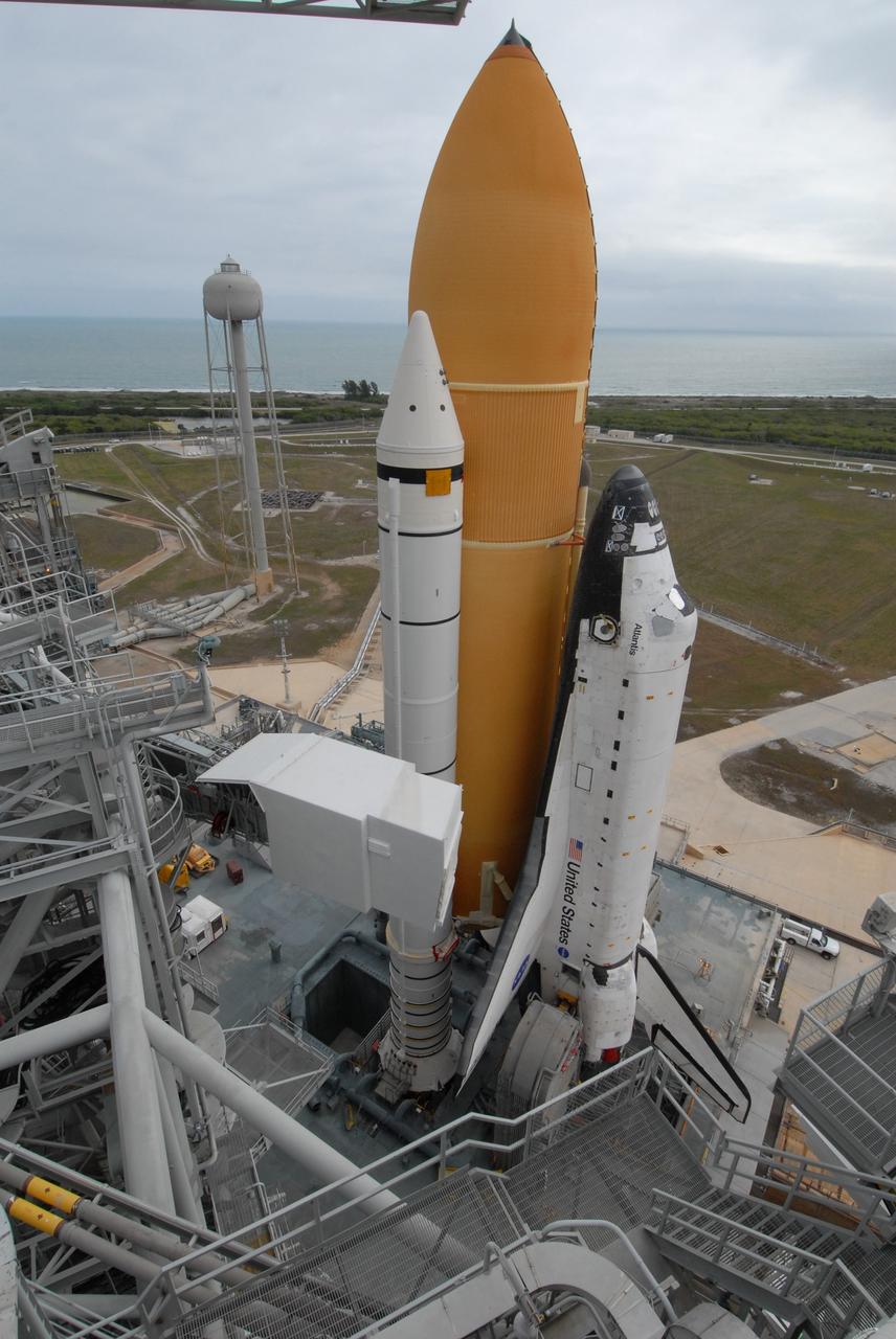 CAPE CANAVERAL, Fla. – Space shuttle Atlantis sits on Launch Pad 39A at NASA's Kennedy Space Center in Florida after rollout from the Vehicle Assembly Building. The shuttle sits atop the mobile launcher platform, which is carried by the crawler-transporter beneath. Beyond the shuttle on the horizon is the Atlantic Ocean. At left, behind the shuttle, is the 300,000-gallon water tower which releases water over the pad for sound suppression during liftoff. First motion was at 3:54 a.m. EDT and Atlantis was secured on the pad at 11:17 a.m. The 3.4-mile trip took about seven-and-a-half hours. Atlantis is targeted to lift off May 12 to service NASA's Hubble Space Telescope. During Atlantis' 11-day mission, the crew of seven astronauts will make the final shuttle flight to Hubble. During five spacewalks, they will install two new instruments, repair two inactive ones and replace components. The result will be six working, complementary science instruments with capabilities beyond what is now available, and an extended operational lifespan for the telescope through at least 2014. Photo credit: NASA/Jack Pfaller
